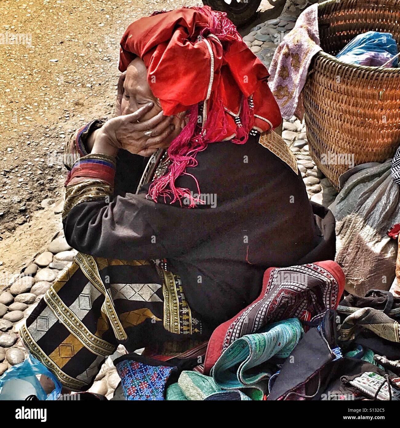 Red Dao woman selling her wares in Sapa Vietnam. Stock Photo
