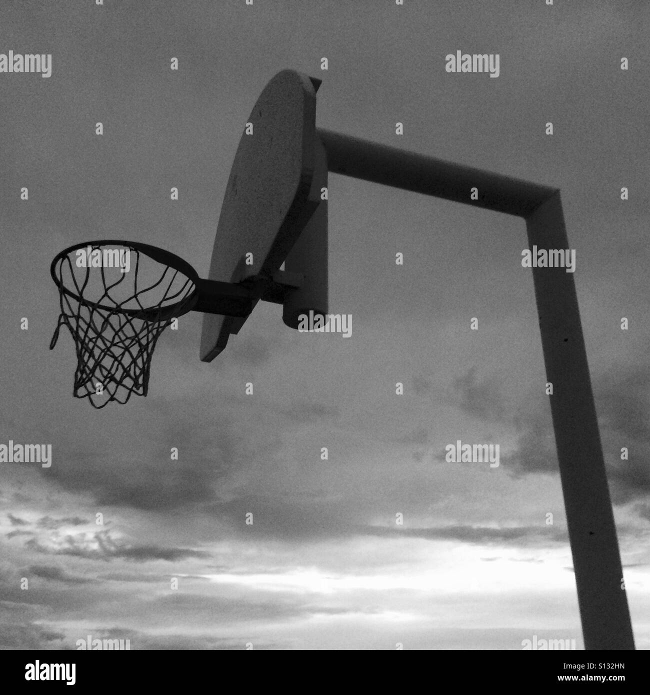 Basketball hoop and net before a sunset. Stock Photo