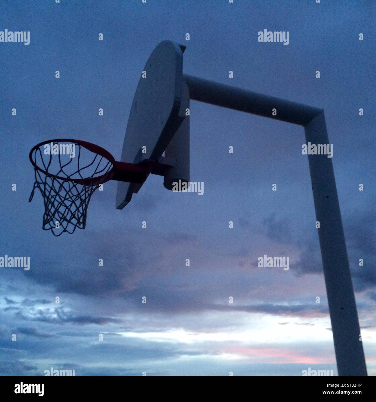 Playground basketball hoop before a sunset. Stock Photo