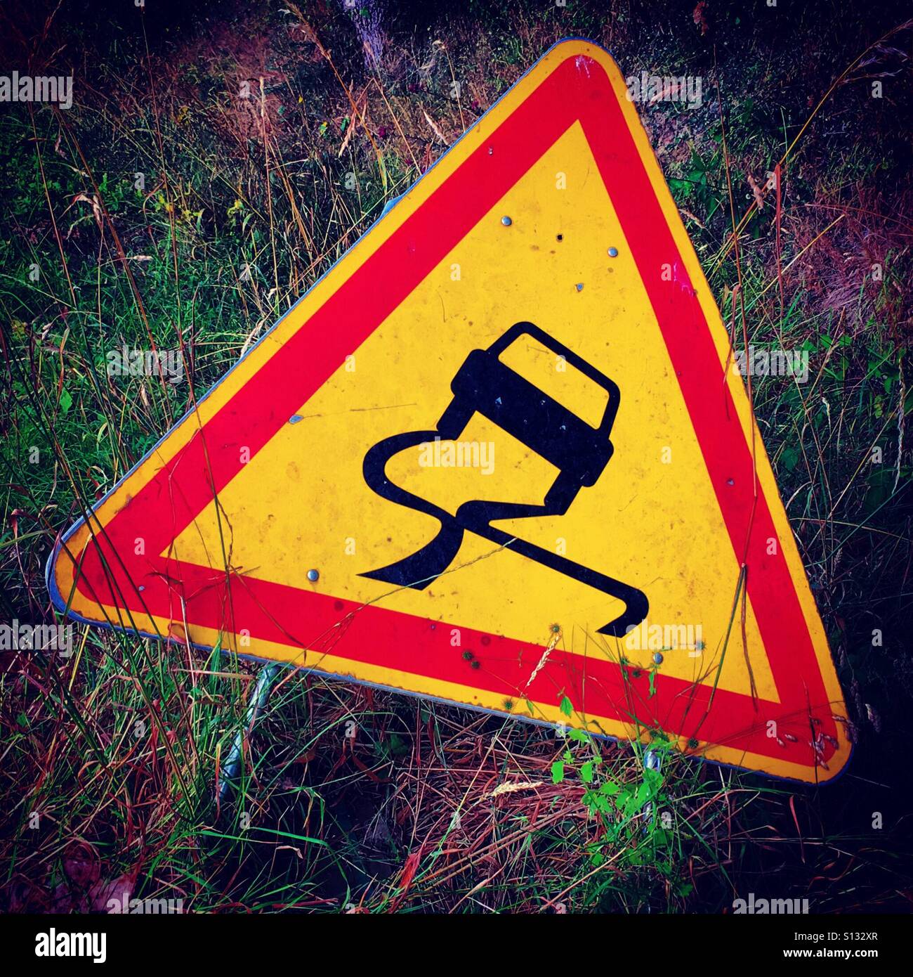 roas sign about slippery road - Smartphone Captured Stock Image