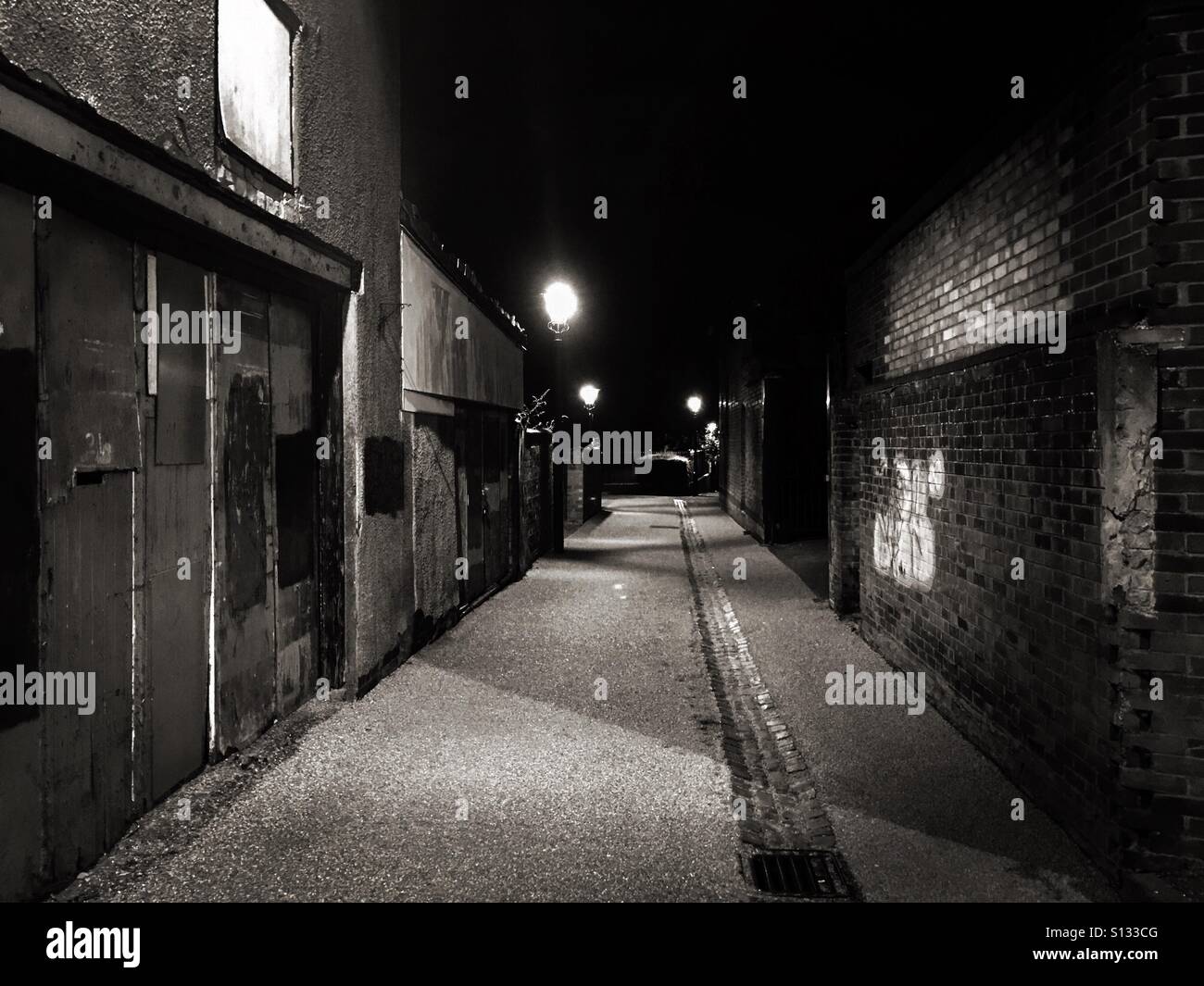 Rundown, dark, seedy and secluded back alley. - Smartphone Captured Stock Image