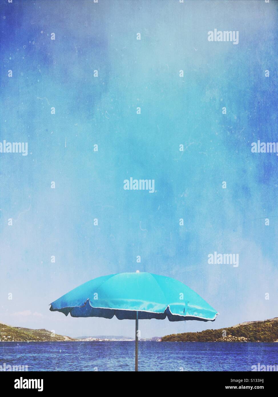 Beach umbrella at waterfront - Smartphone Captured Stock Image