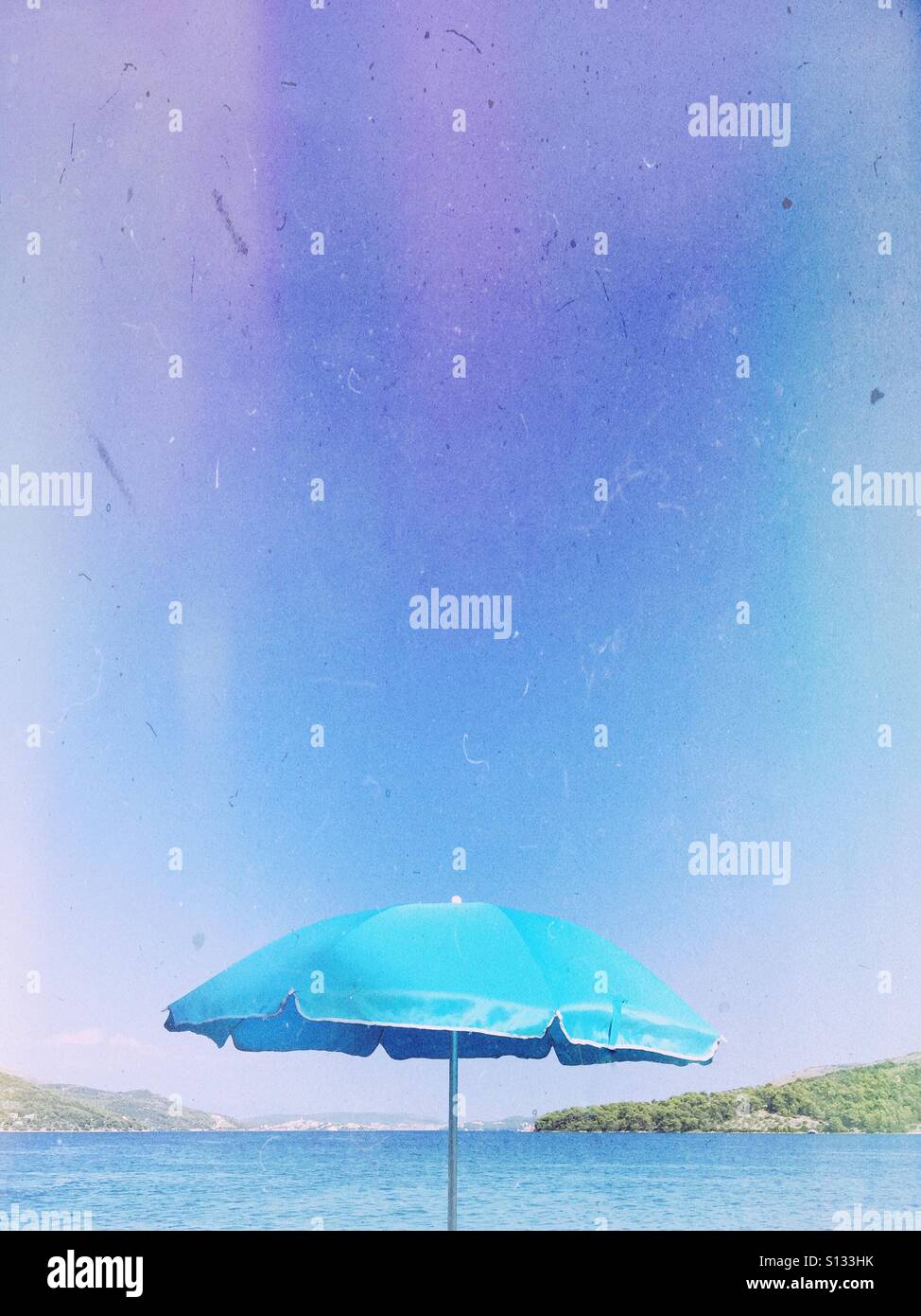 Beach umbrella at waterfront - Smartphone Captured Stock Image