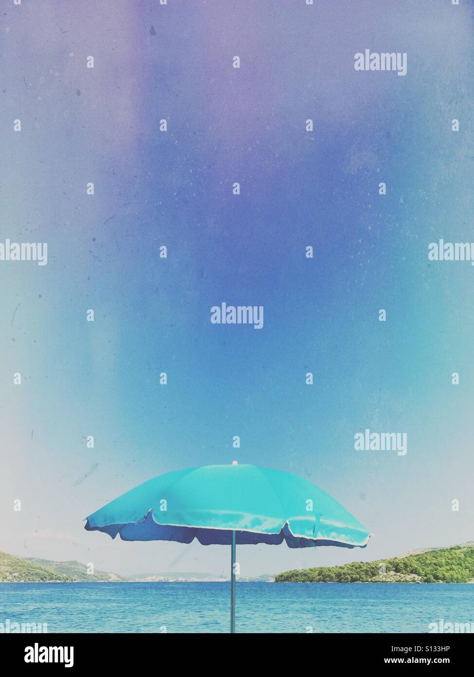 Beach umbrella at waterfront - Smartphone Captured Stock Image