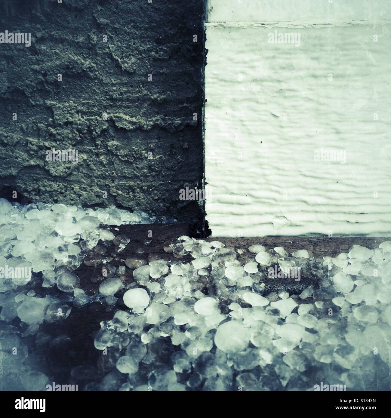 A close look at accumulated hail on a deck outside a house. - Smartphone Captured Stock Image