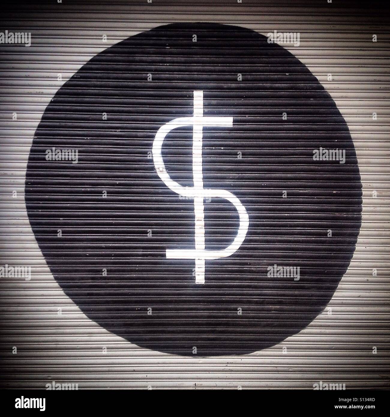 The simbol of the peso, the Mexican money is painted inside a black dot in Mexico City. The simbol of money comes from Saturn and represents a snake on the tree of life. - Smartphone Captured Stock Image