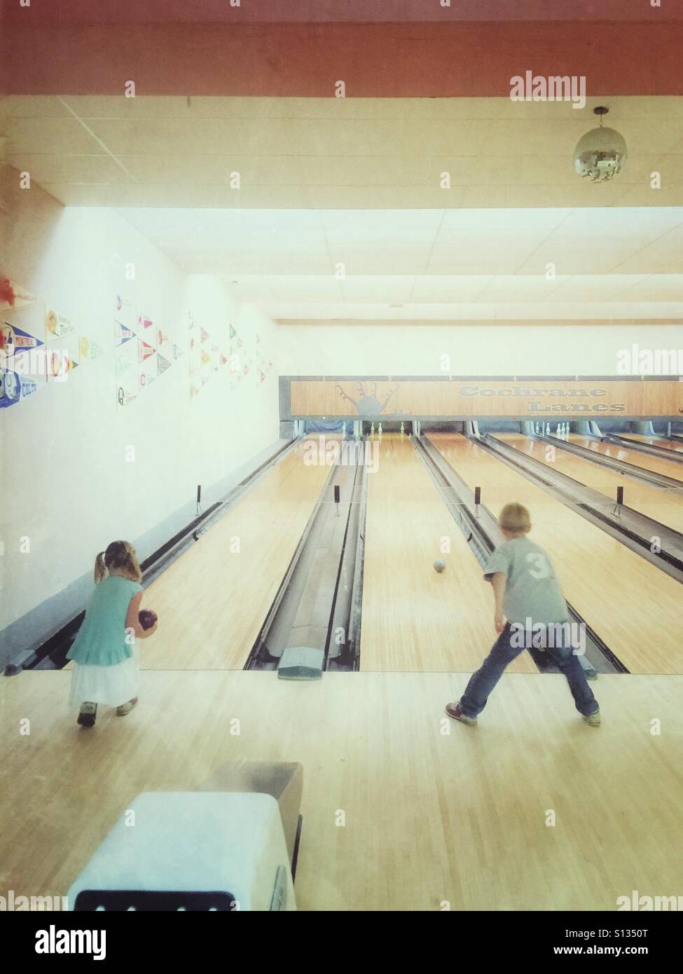Two children bowling Stock Photo Alamy
