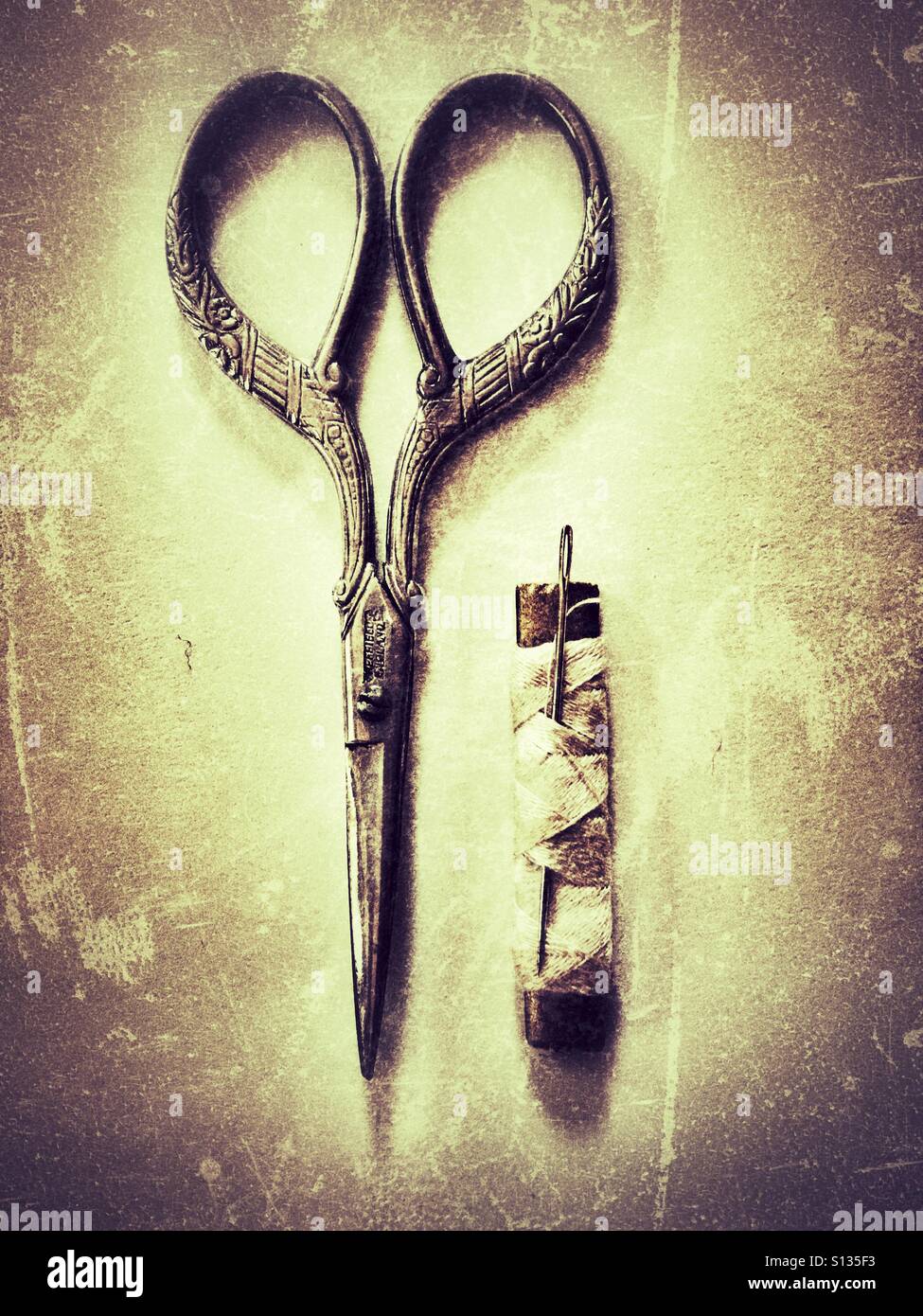 Basic sewing kit. Old pair of scissors, cotton and a needle. - Smartphone Captured Stock Image