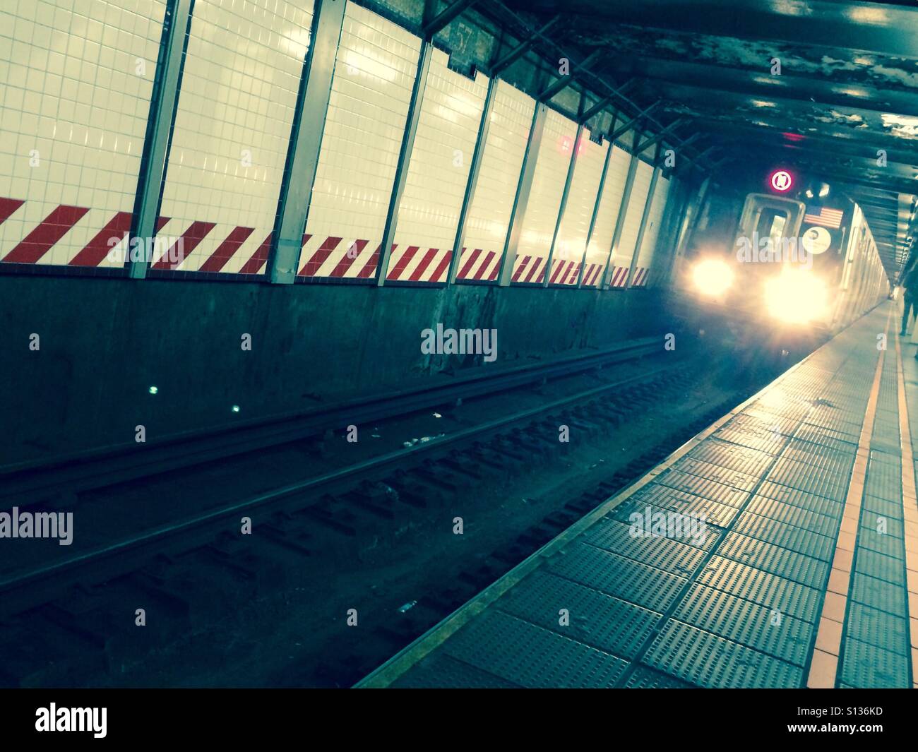 New York City subway car approaches the platform. Stock Photo