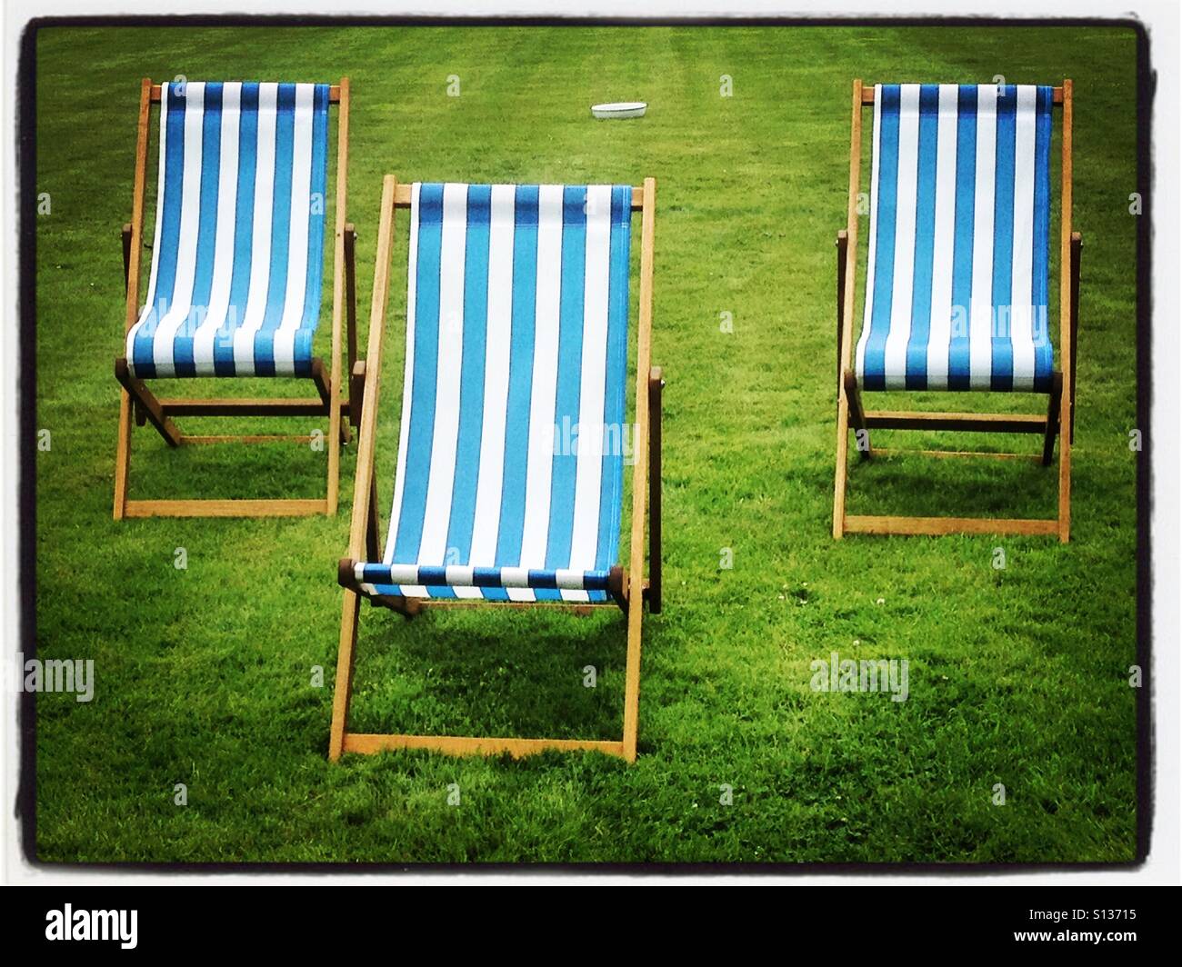 Three empty deckchairs. iPhone photo with some Instagram style processing. - Smartphone Captured Stock Image