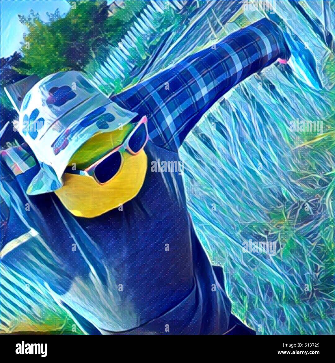 Blue scarecrow with a hat and sunglasses Stock Photo
