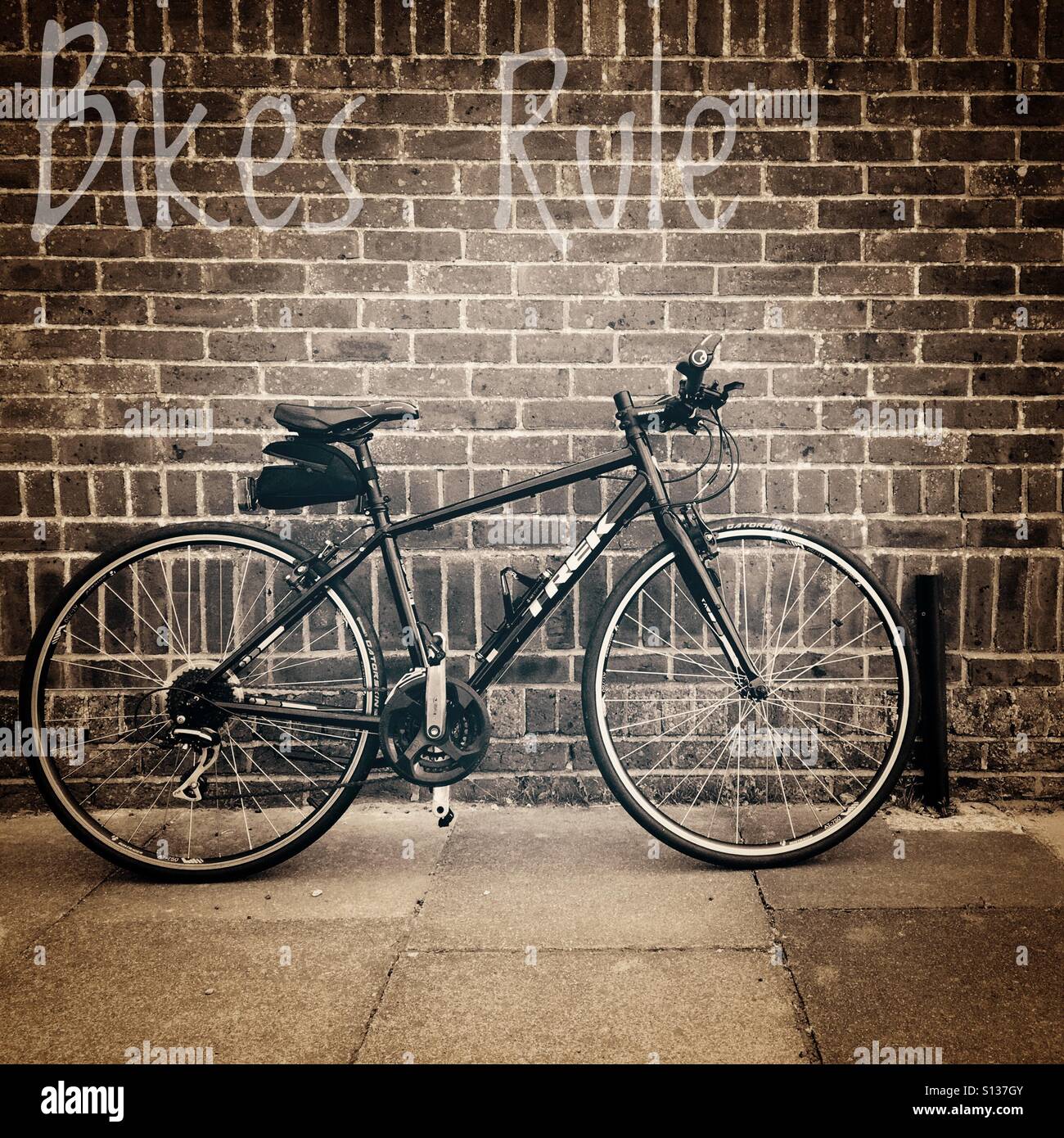 Bikes rule, flat bar street pub bike leaning against brick wall. Stock Photo