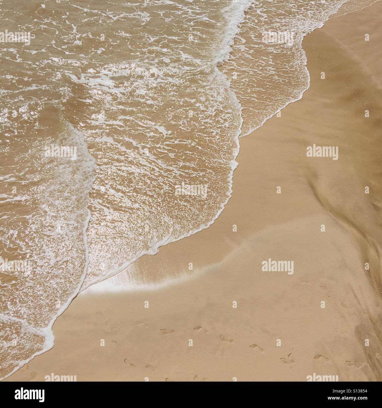 The sea coming in on a sandy beach in St. Ives - Smartphone Captured Stock Image