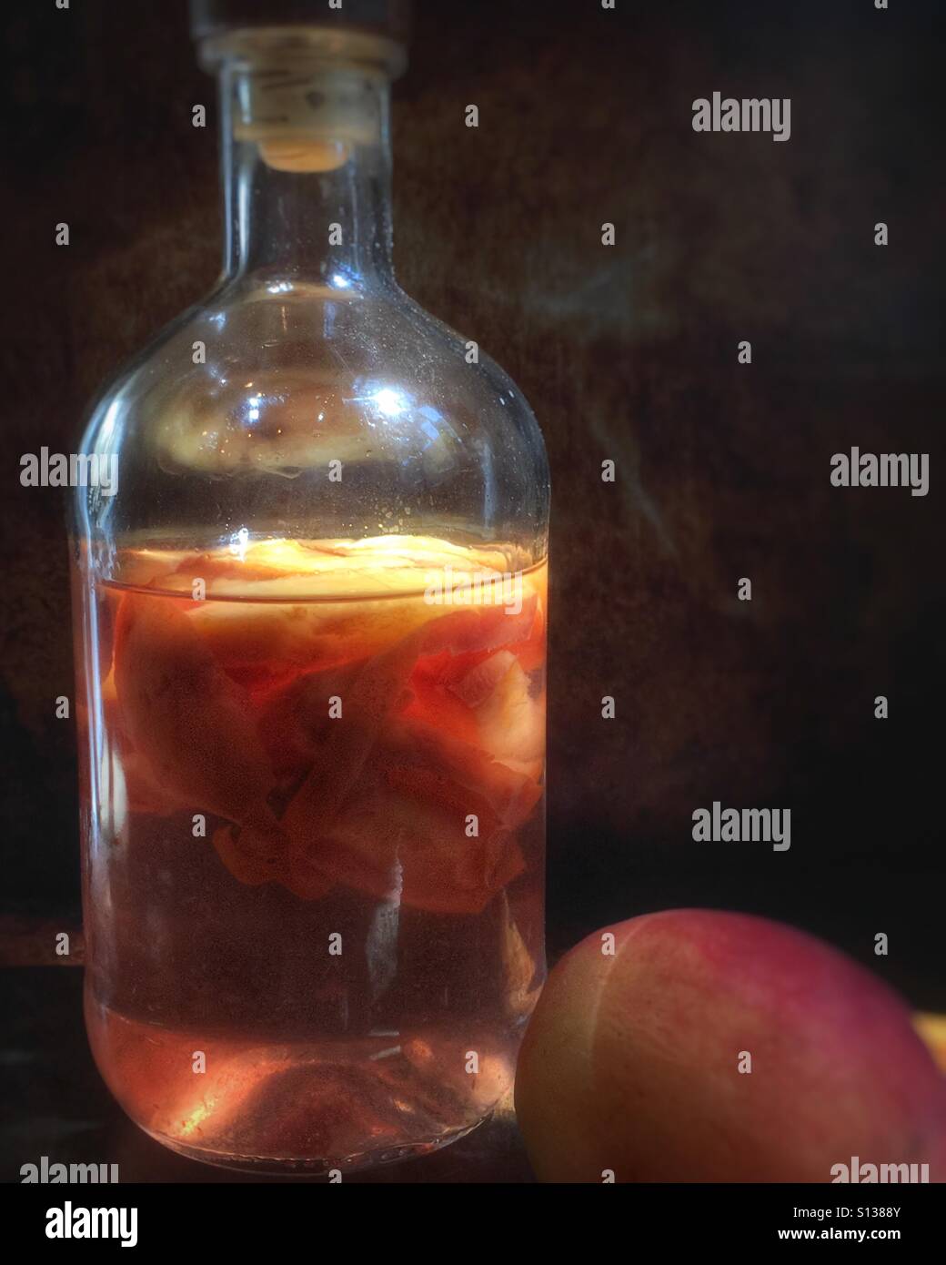 Making peach infused vodka Stock Photo