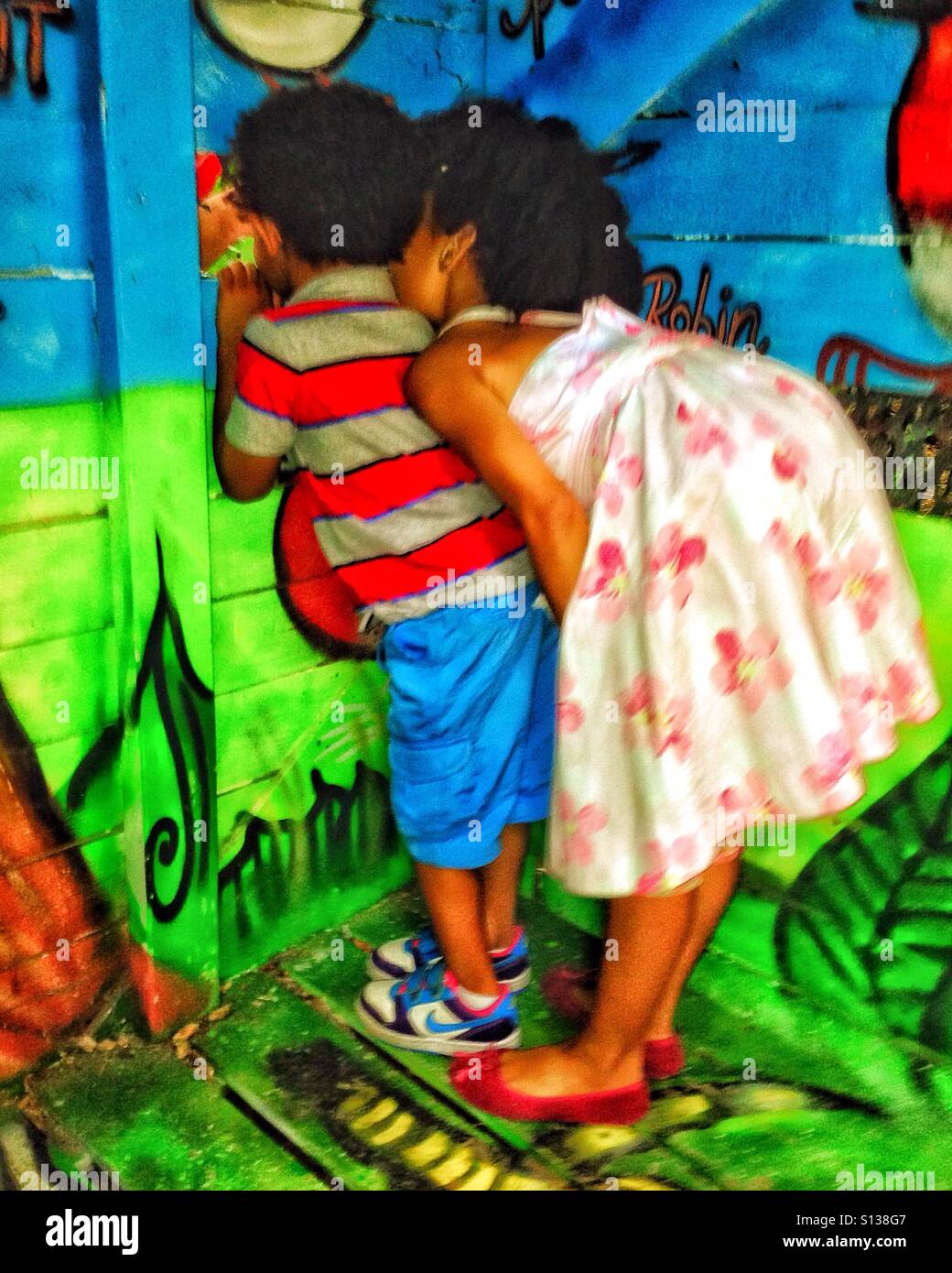 Two children playing in a colourful hut - Smartphone Captured Stock Image