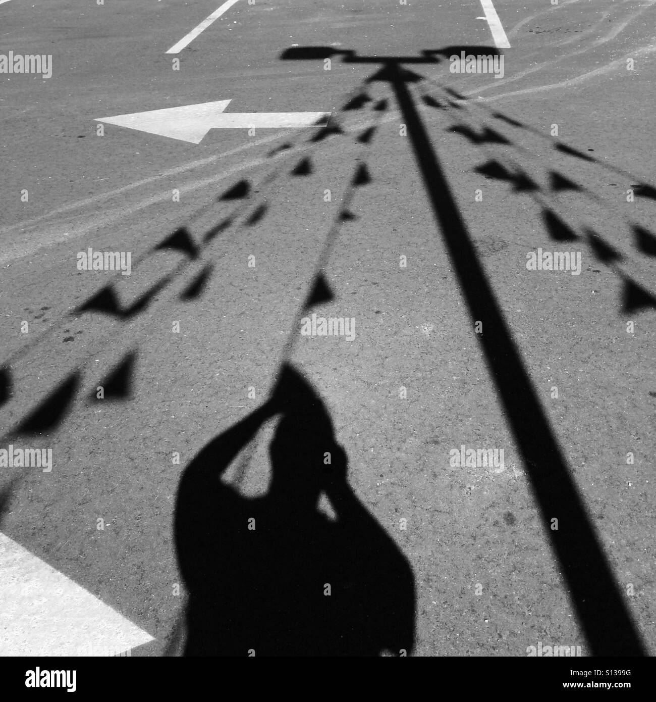 Silhouette of man taking a photo before the shadows of fluttering banners. Stock Photo