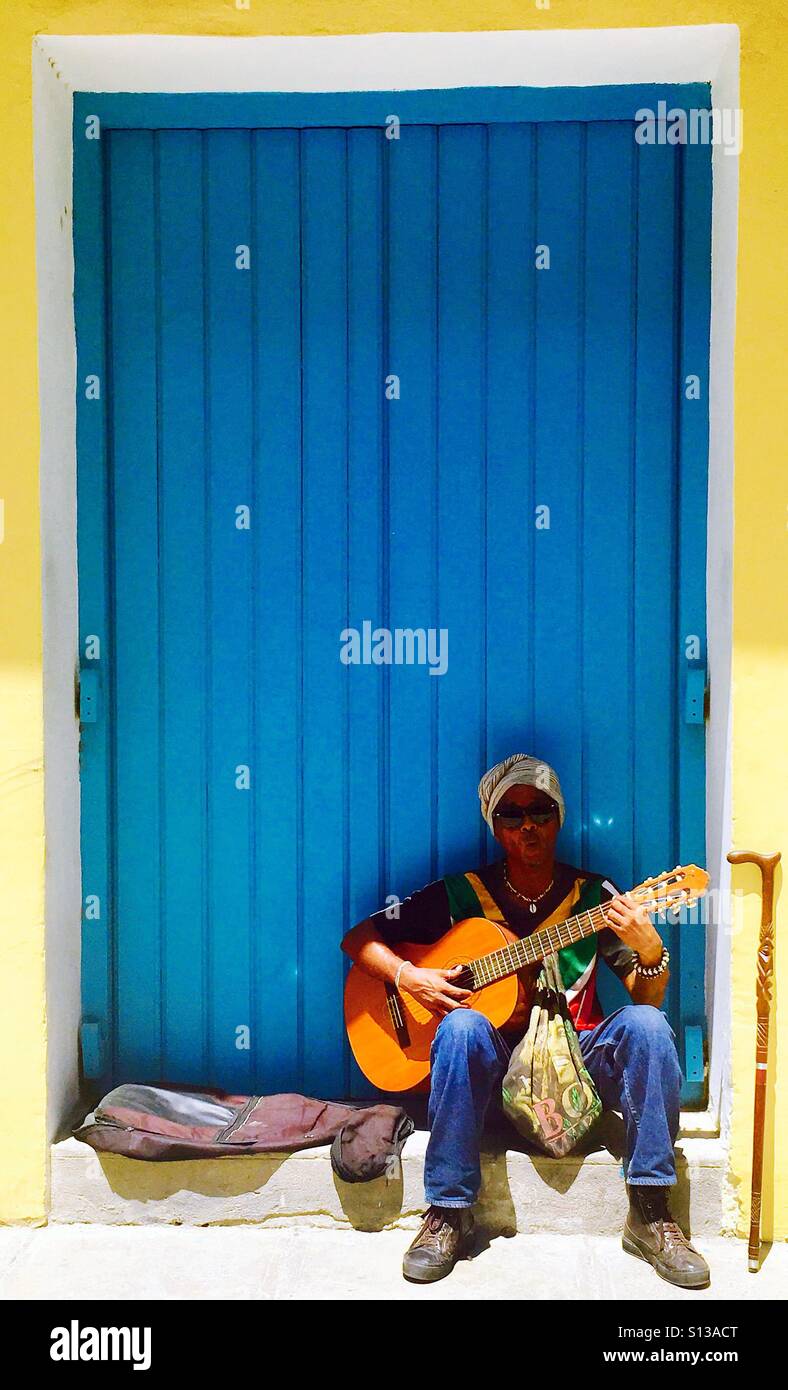 A local musician playing his guitar in old Havana. - Smartphone Captured Stock Image