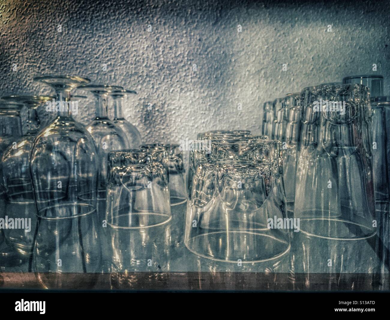 Glasses on a glass shelf. - Smartphone Captured Stock Image