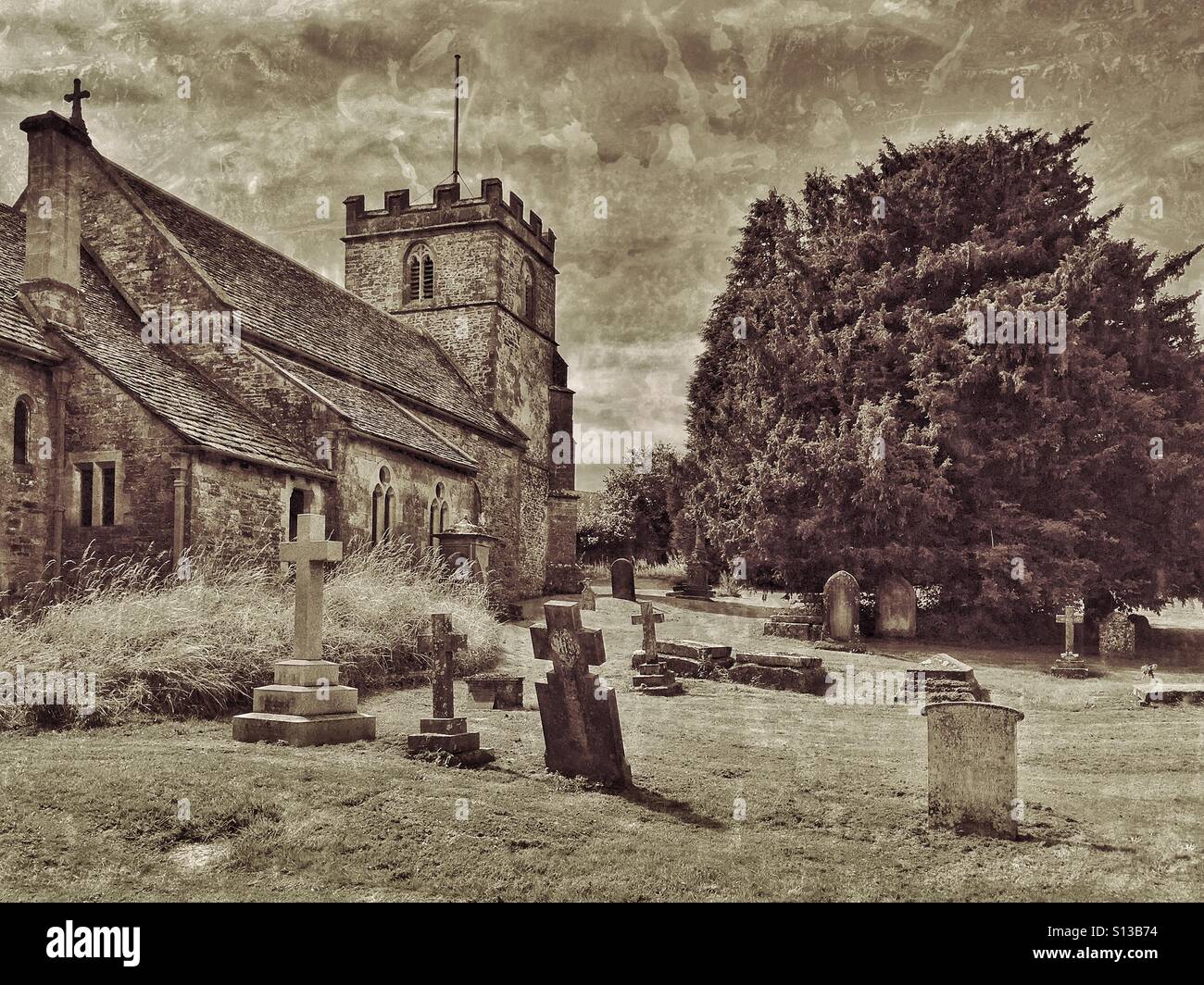 An antique effect picture of The Graveyard & Church of St. Andrew in Miserden, Gloucestershire, England. This Cotswold Church dates frm the 11th Century & is a Grade 2 listed building. © COLIN HOSKINS - Smartphone Captured Stock Image