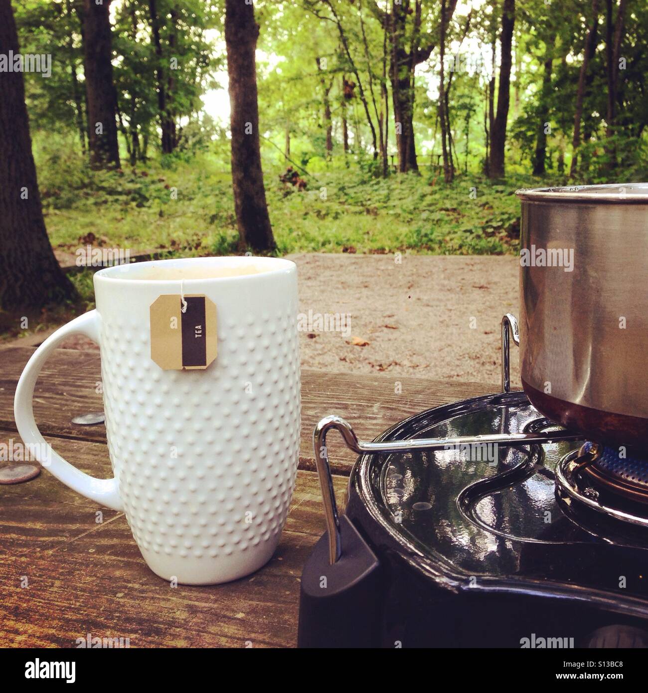 Morning tea made on camp stove Stock Photo Alamy