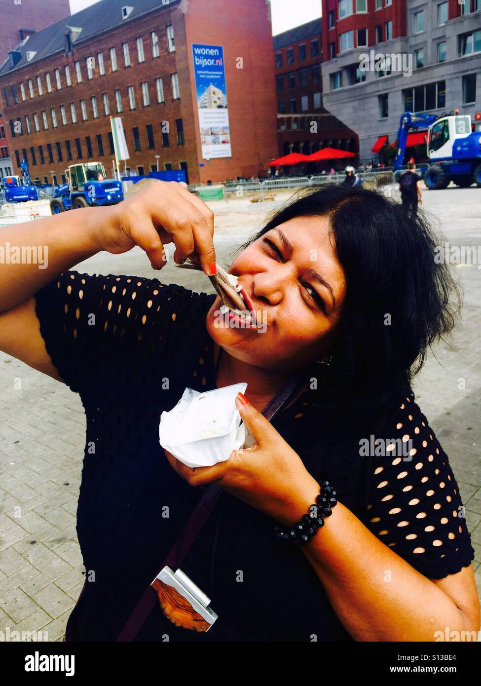Enjoying raw herring in Holland Stock Photo Alamy
