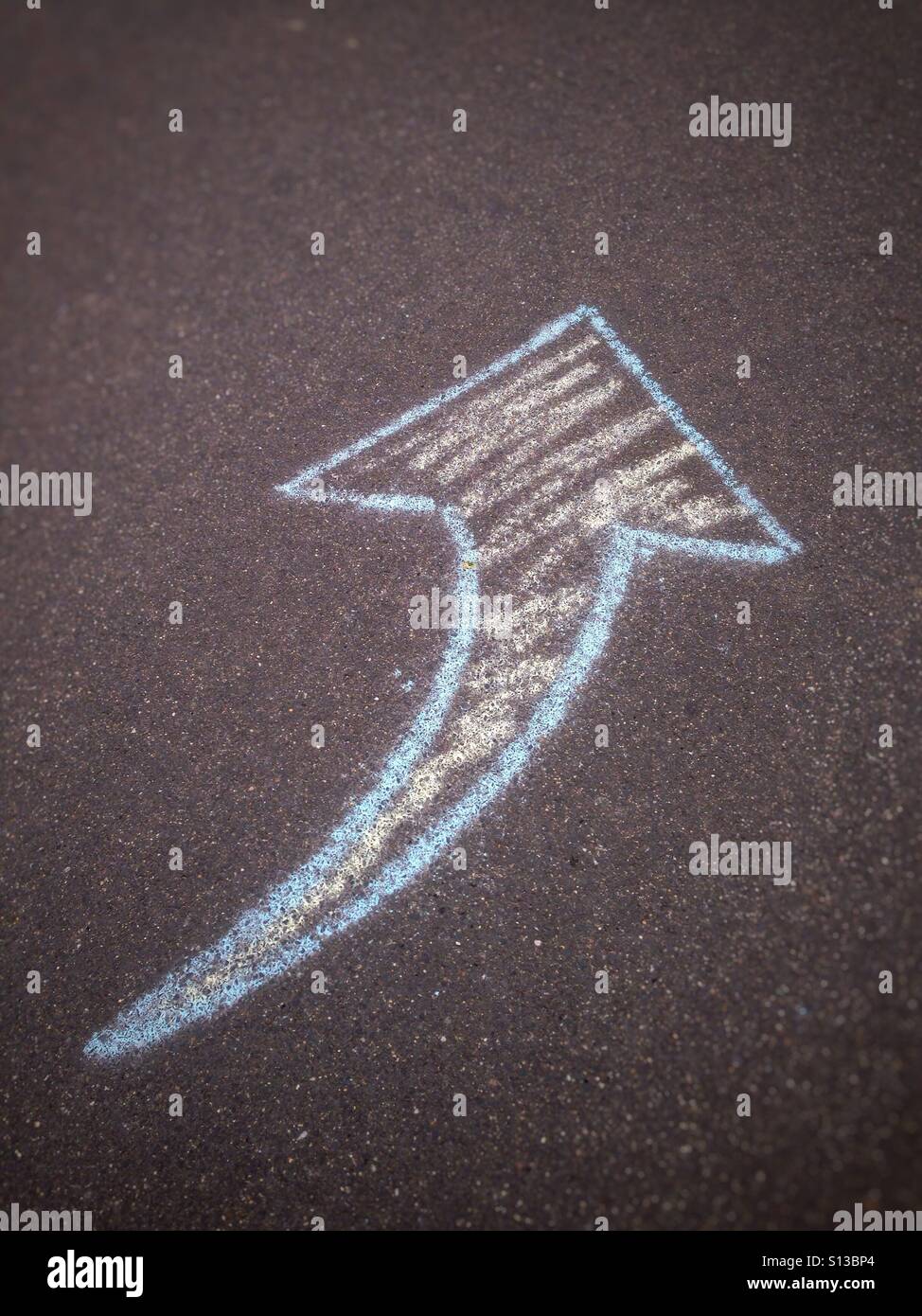 Chalk arrow drawn on the sidewalk - Smartphone Captured Stock Image