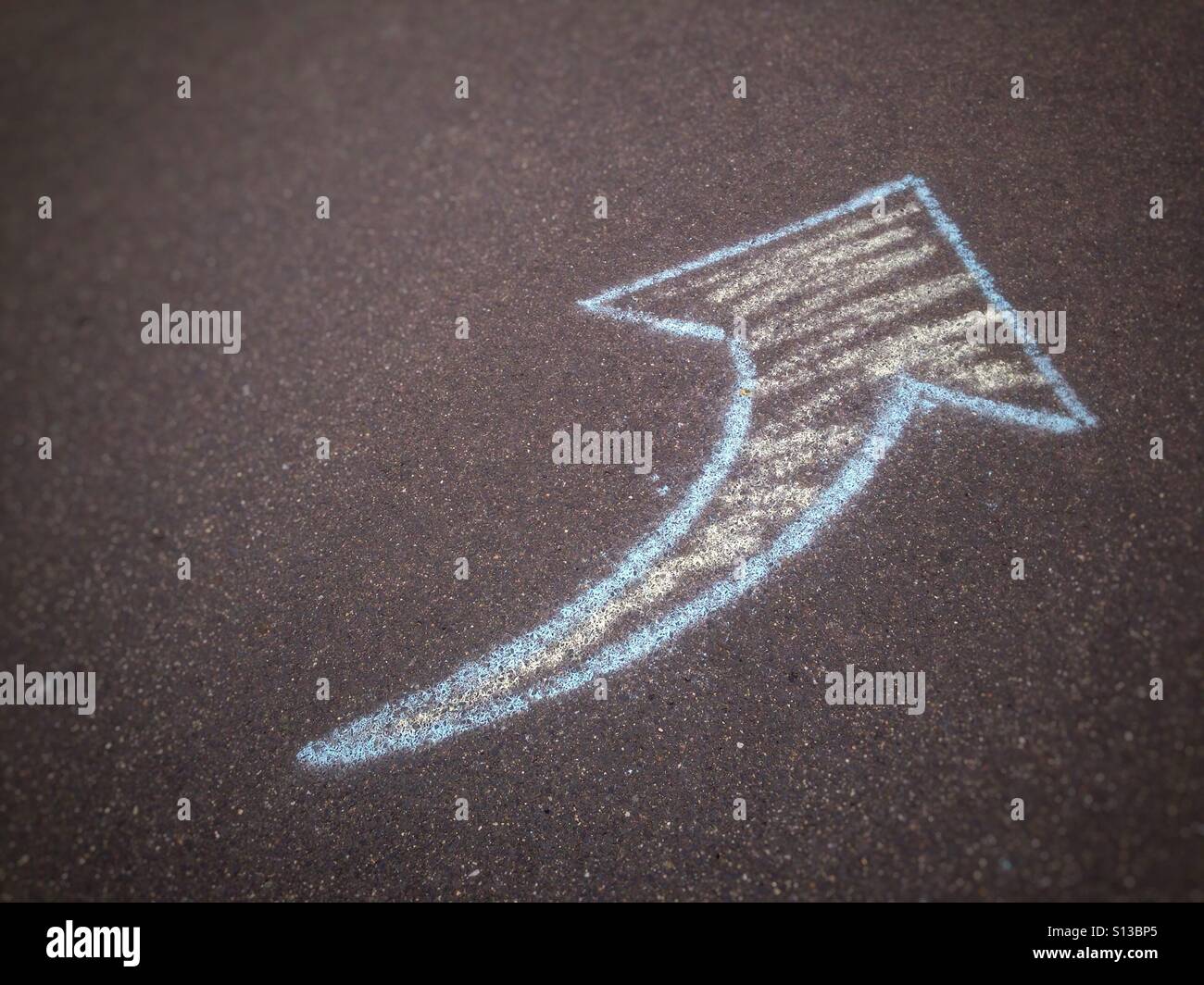 Chalk arrow drawn on the sidewalk - Smartphone Captured Stock Image