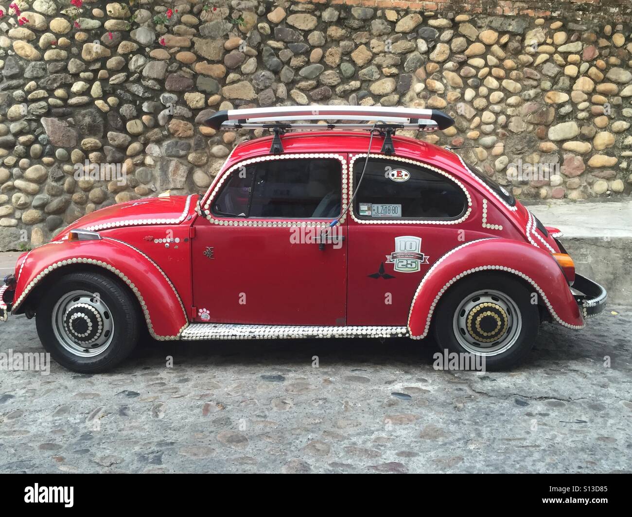 Red Volkswagen beetle parked near the beach in Puerto Vallarta, Mexico. Stock Photo