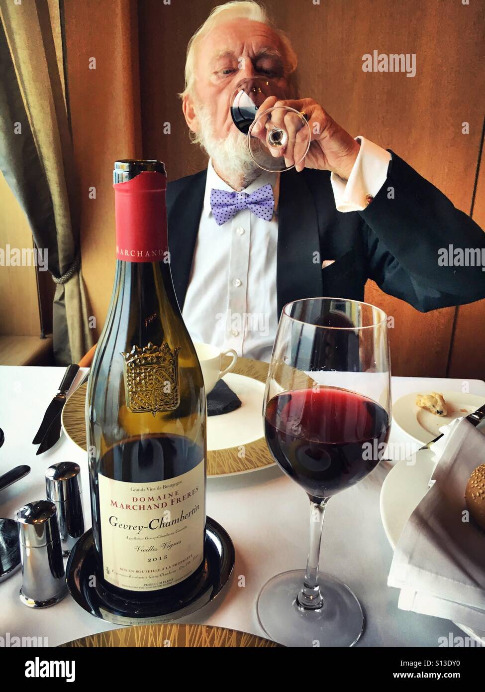 Formal gentleman enjoys a glass of red wine Stock Photo