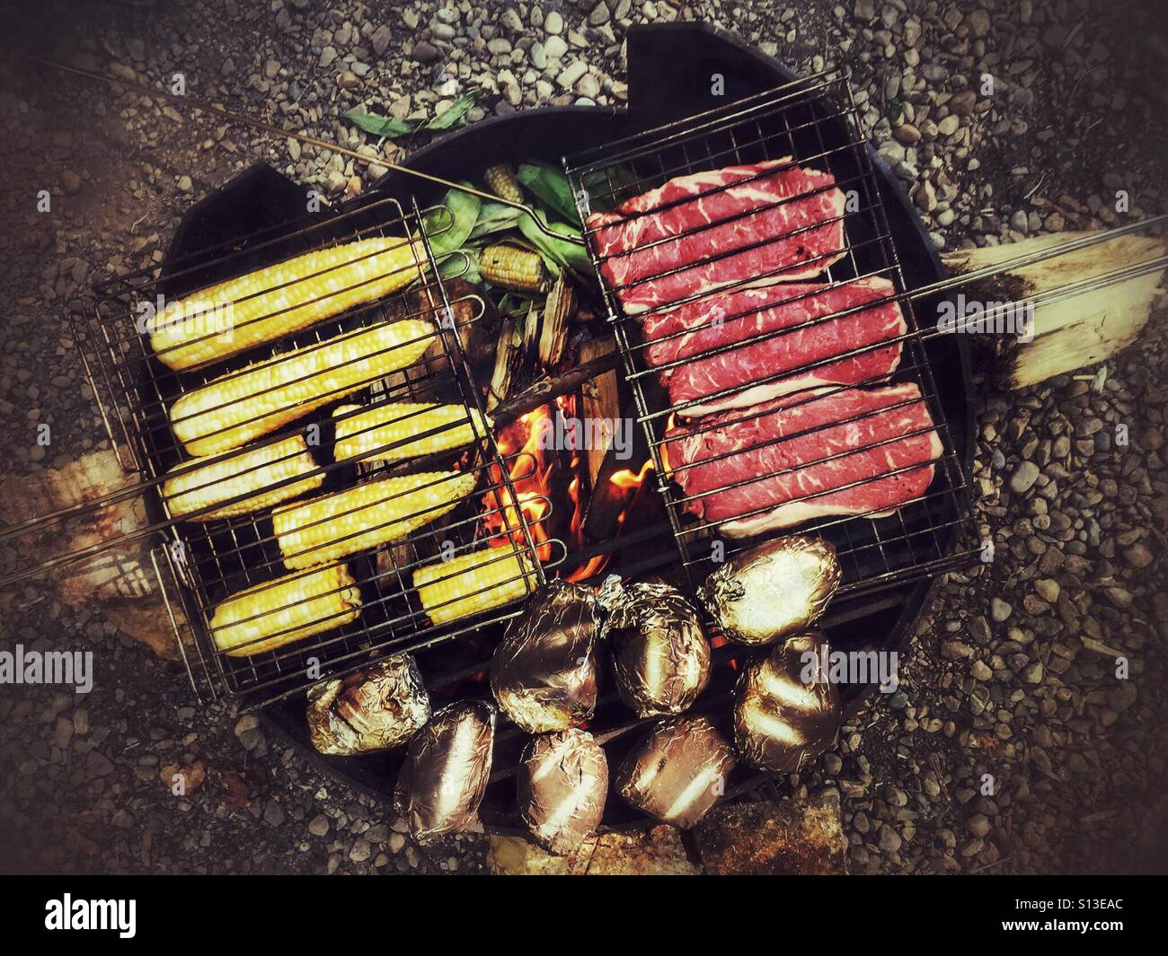 Cooking a large family meal on an open fire. Stock Photo