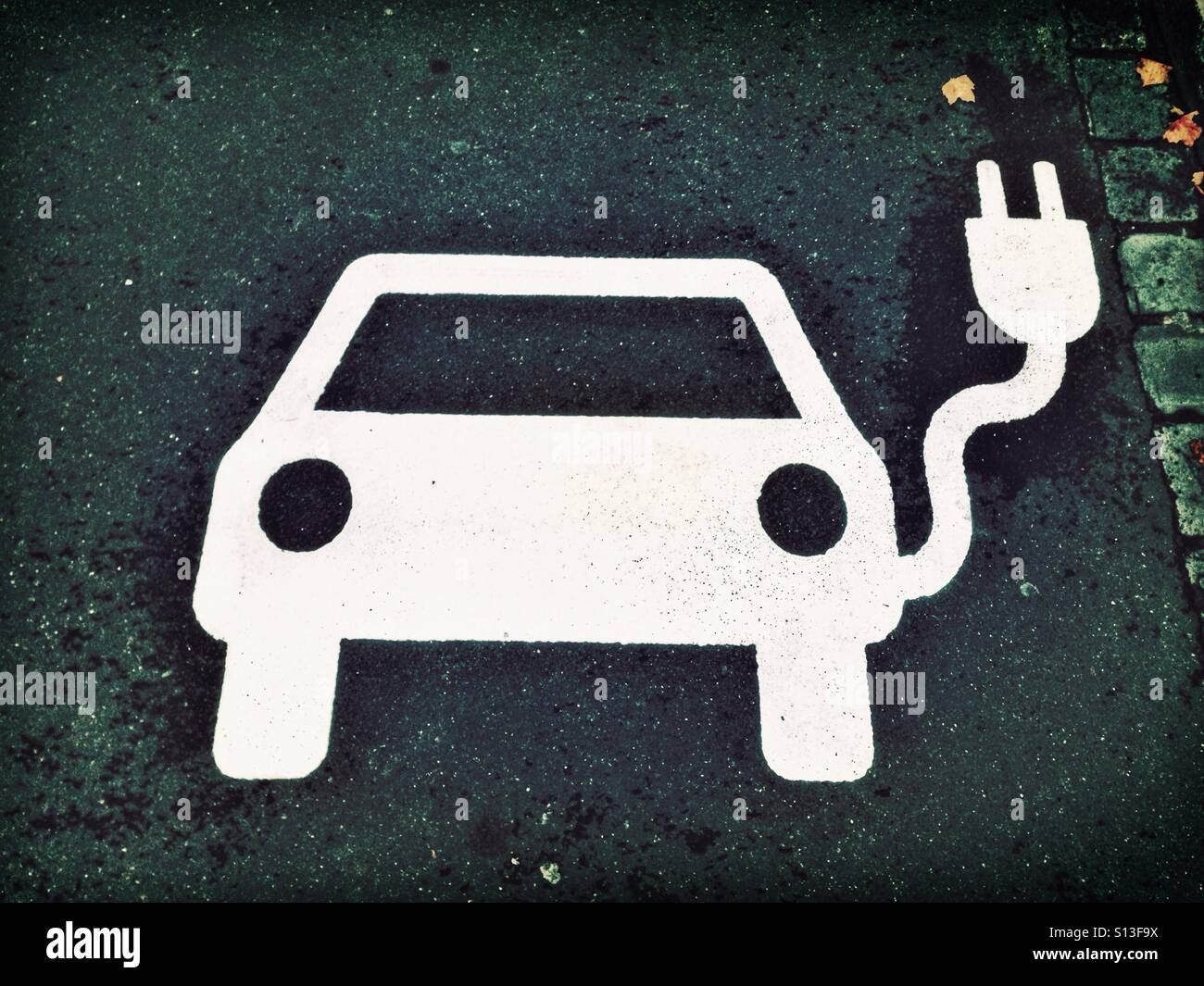 White E car symbol on the tarmac - Smartphone Captured Stock Image