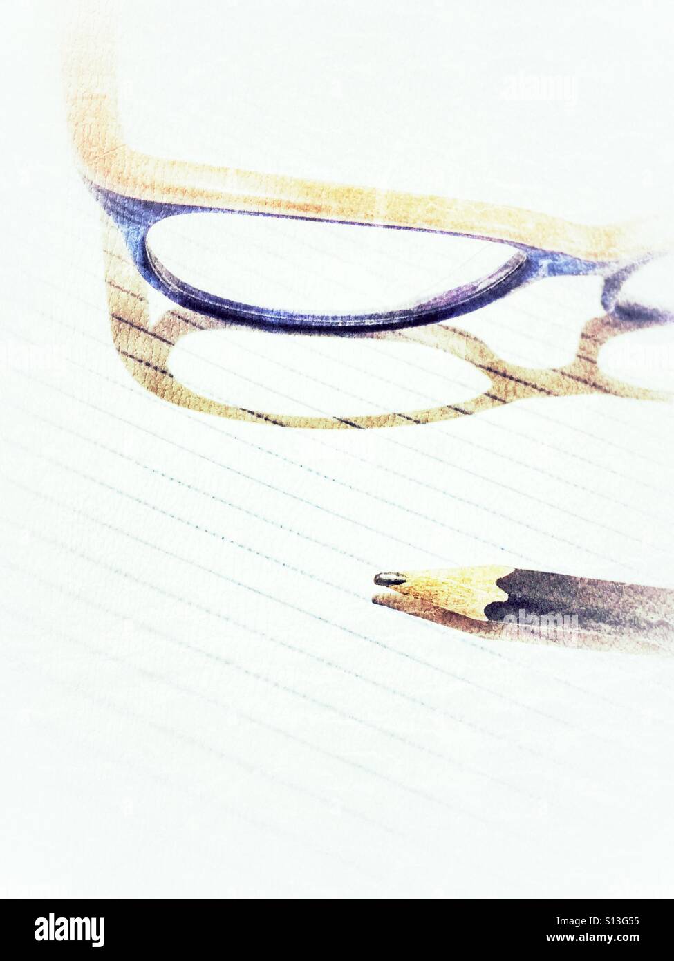 Child glasses and pencil on a notebook page. Stock Photo
