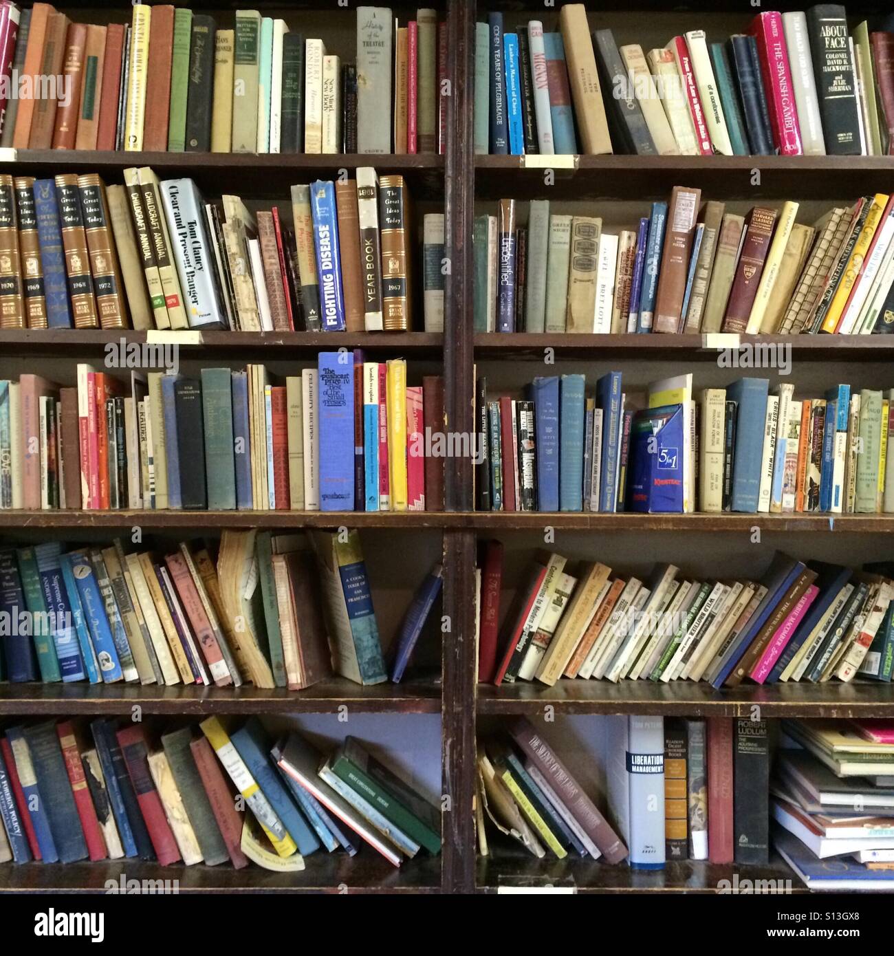 Bookshelf filled with old books. Stock Photo