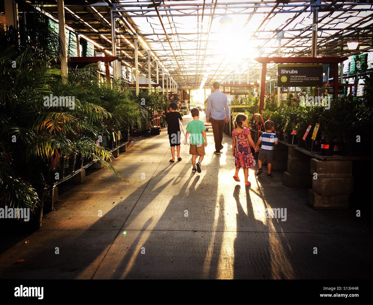 Family walking around a garden center Stock Photo