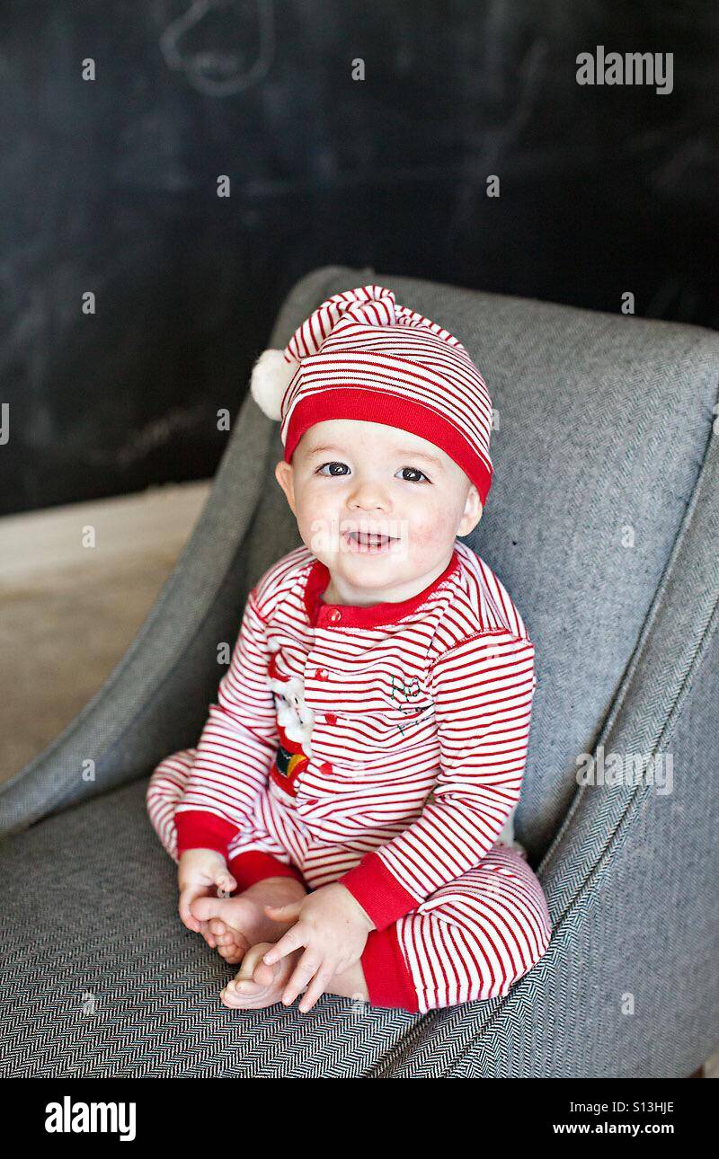 Baby in Christmas red and white stripped pajamas Stock Photo