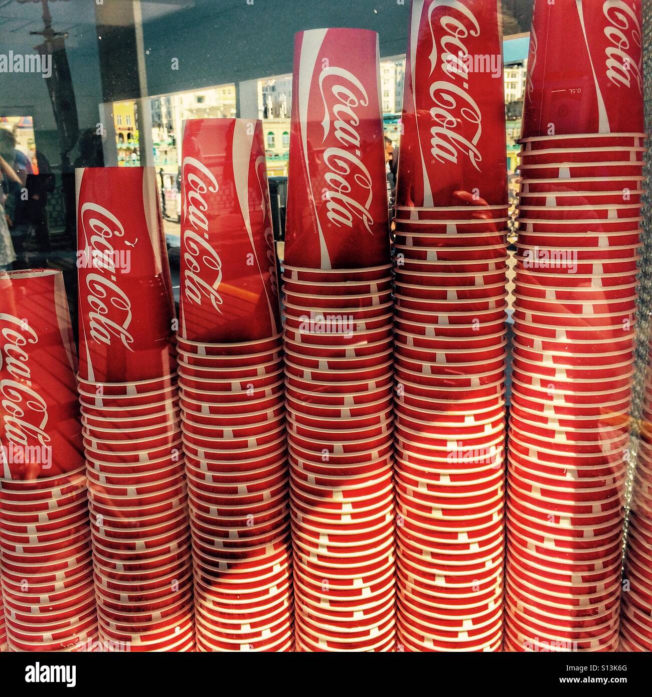 Stacked up Coca Cola drink paper cups in a shop window Stock Photo - Alamy