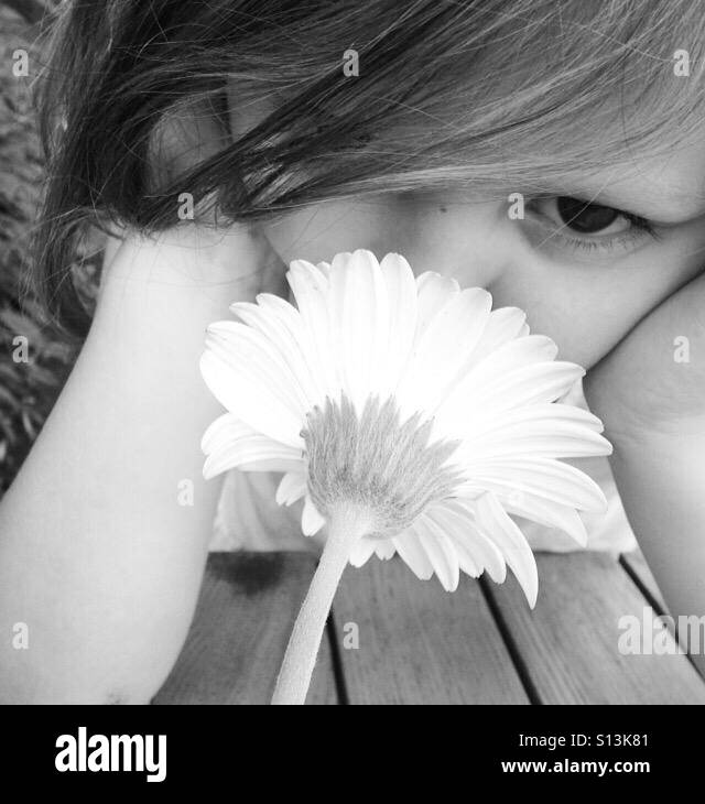 Girl smelling flower Stock Photo Alamy