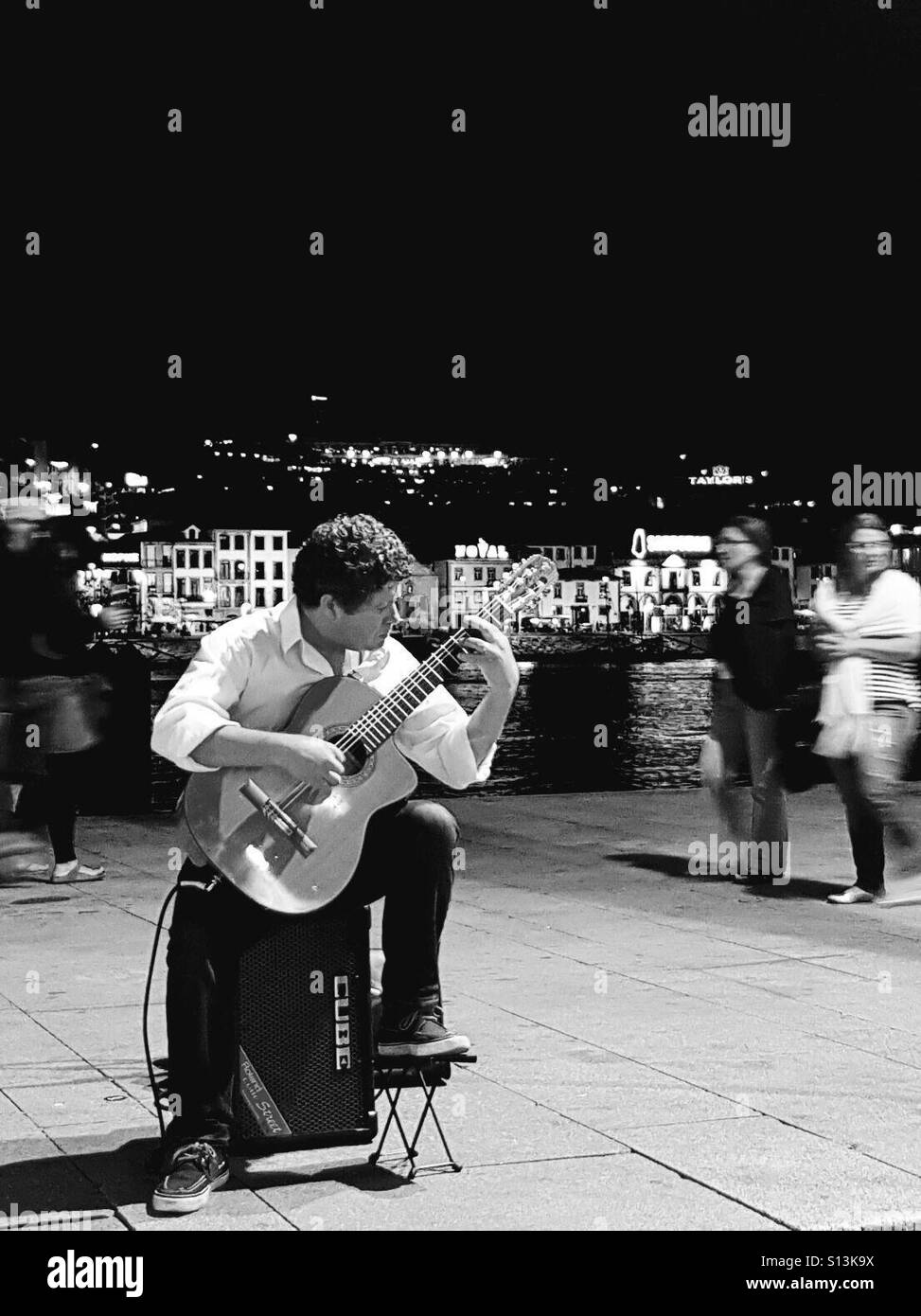 Guitar playing street performer by Rio Douro, Porto, Portugal Stock Photo