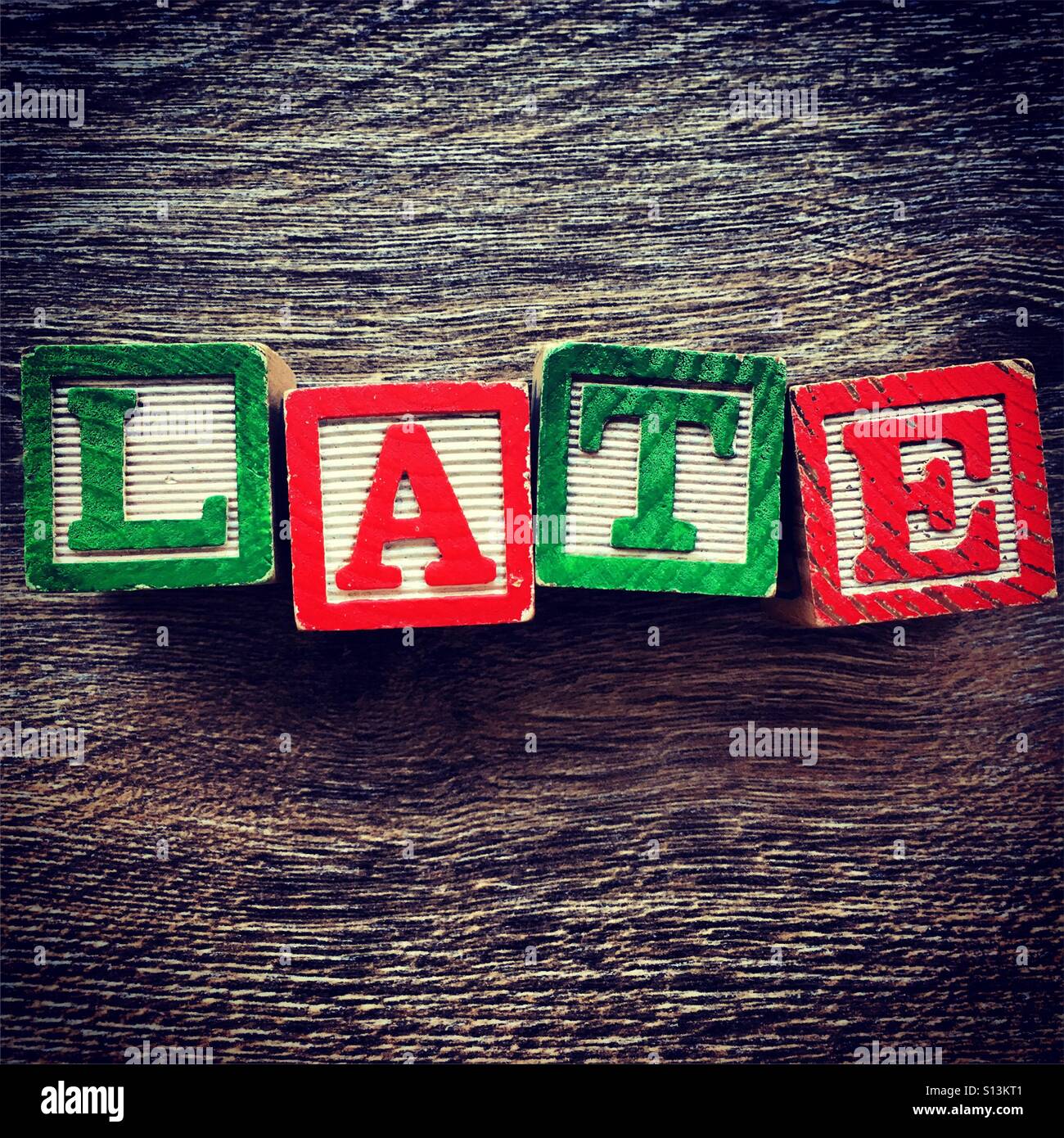 LATE word written with wood block letter toys - Smartphone Captured Stock Image