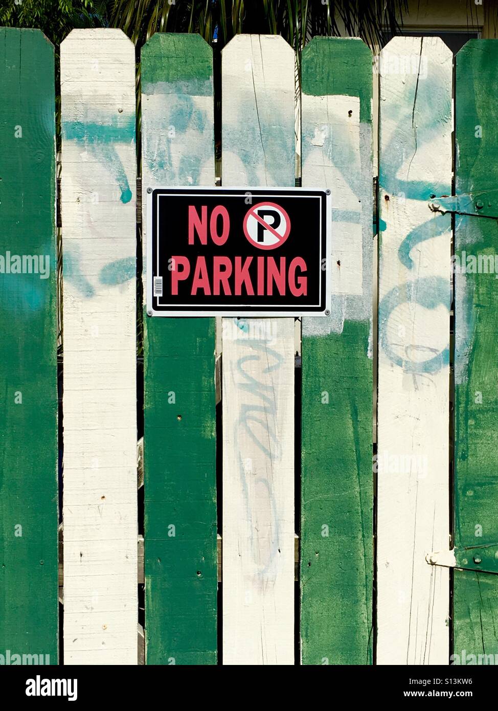 No parking sign on green and white fence - Smartphone Captured Stock Image
