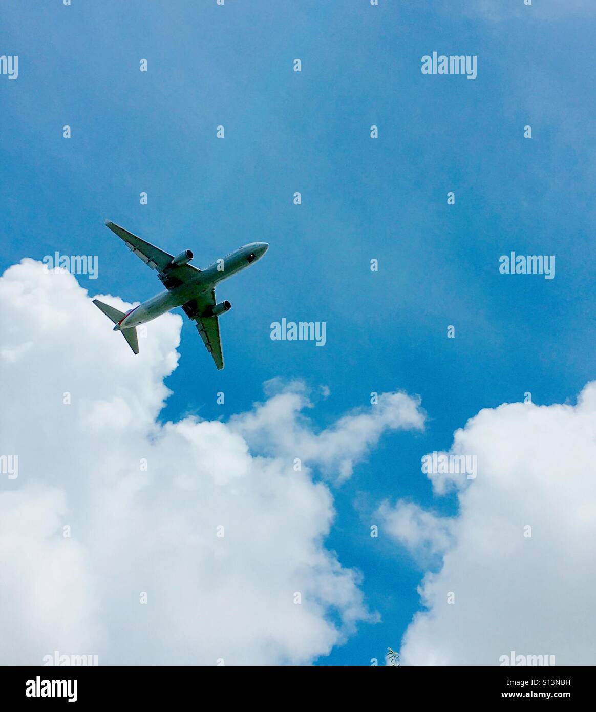 Jet plane in the sky with clouds - Smartphone Captured Stock Image