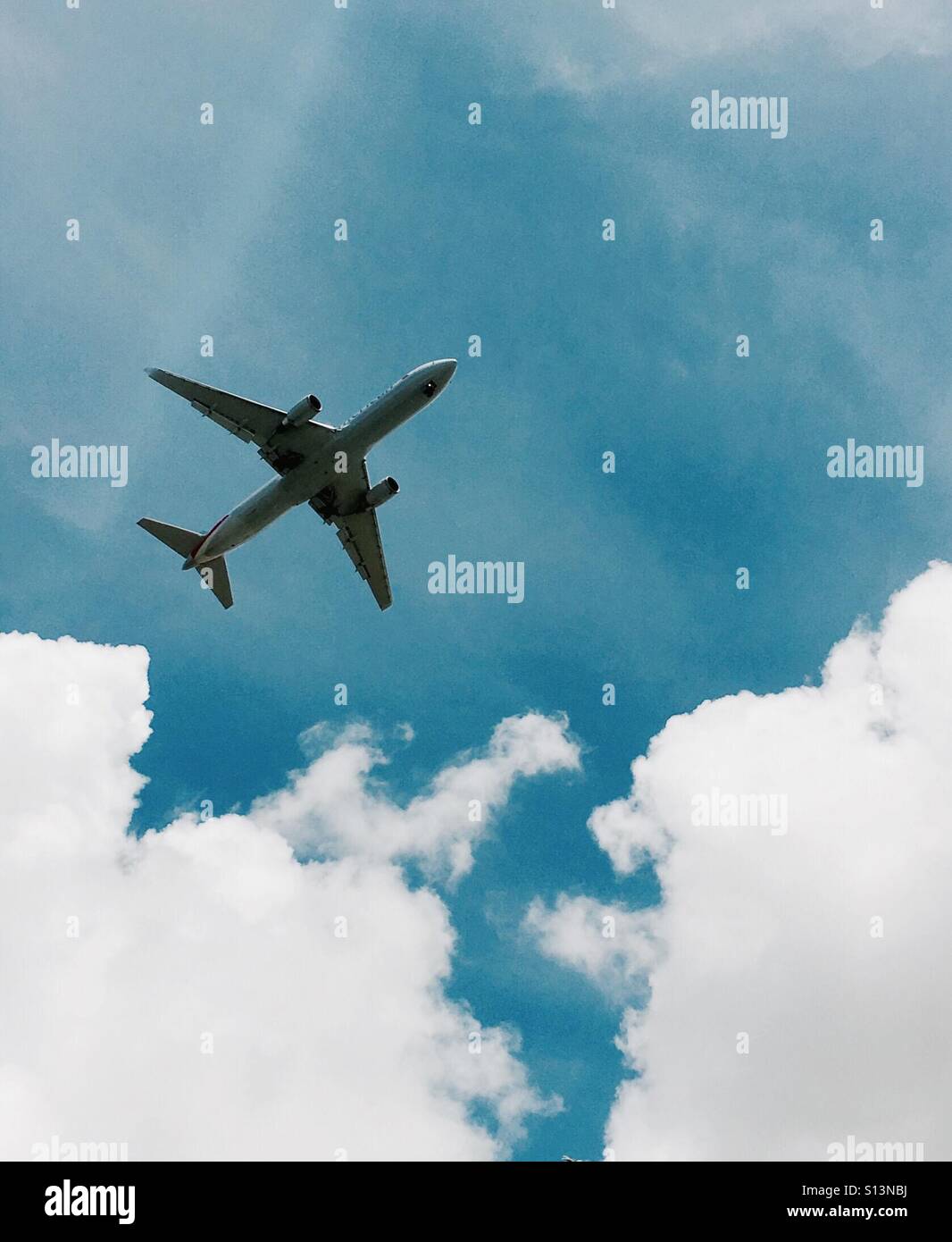 Jet plane in the sky with clouds - Smartphone Captured Stock Image