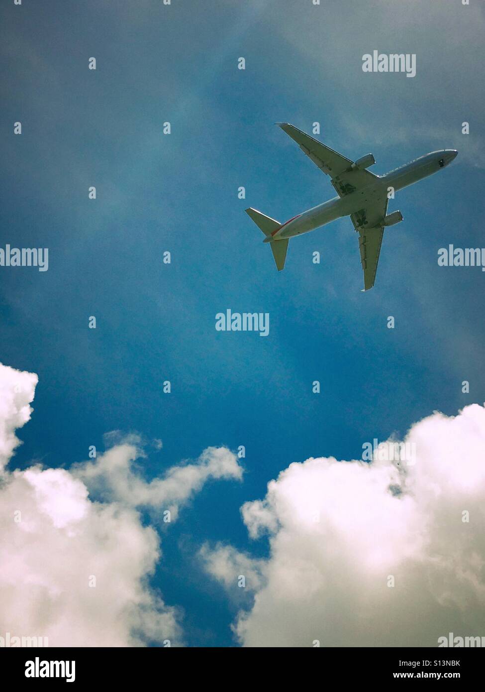 Jet in sky with clouds - Smartphone Captured Stock Image