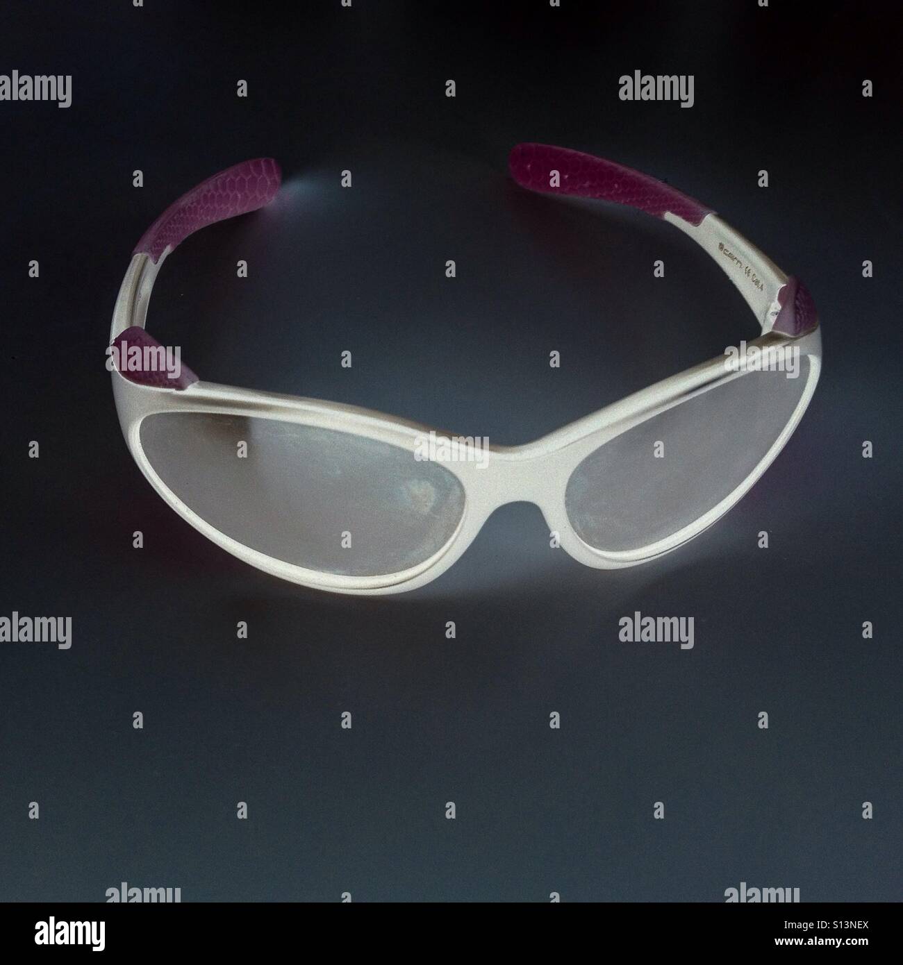 Sunglasses on a white table in negative - Smartphone Captured Stock Image