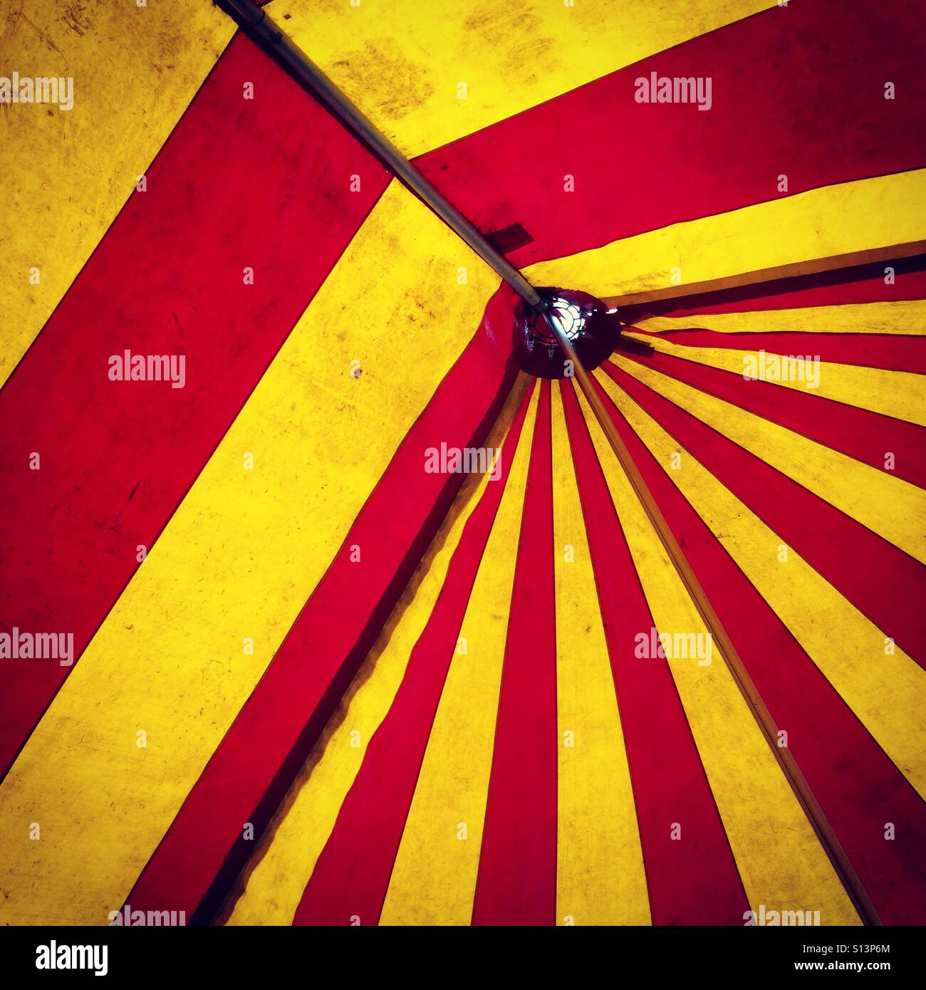 The inside of a red and yellow big top circus tent Stock Photo