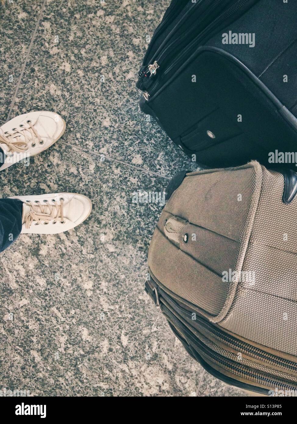 Looking down at the legs and luggage Stock Photo