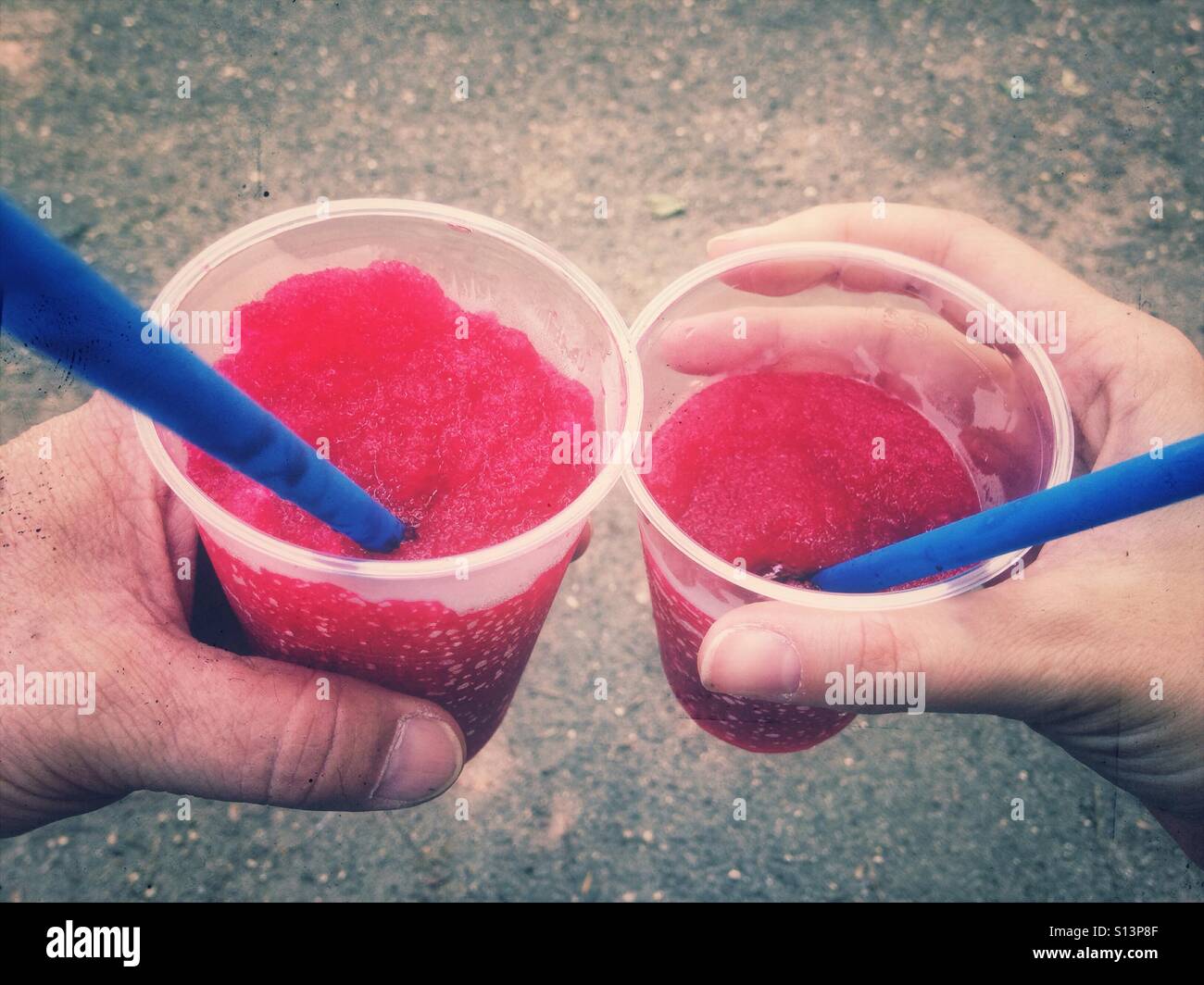 crushed ice drinks with straws in hands Stock Photo - Alamy