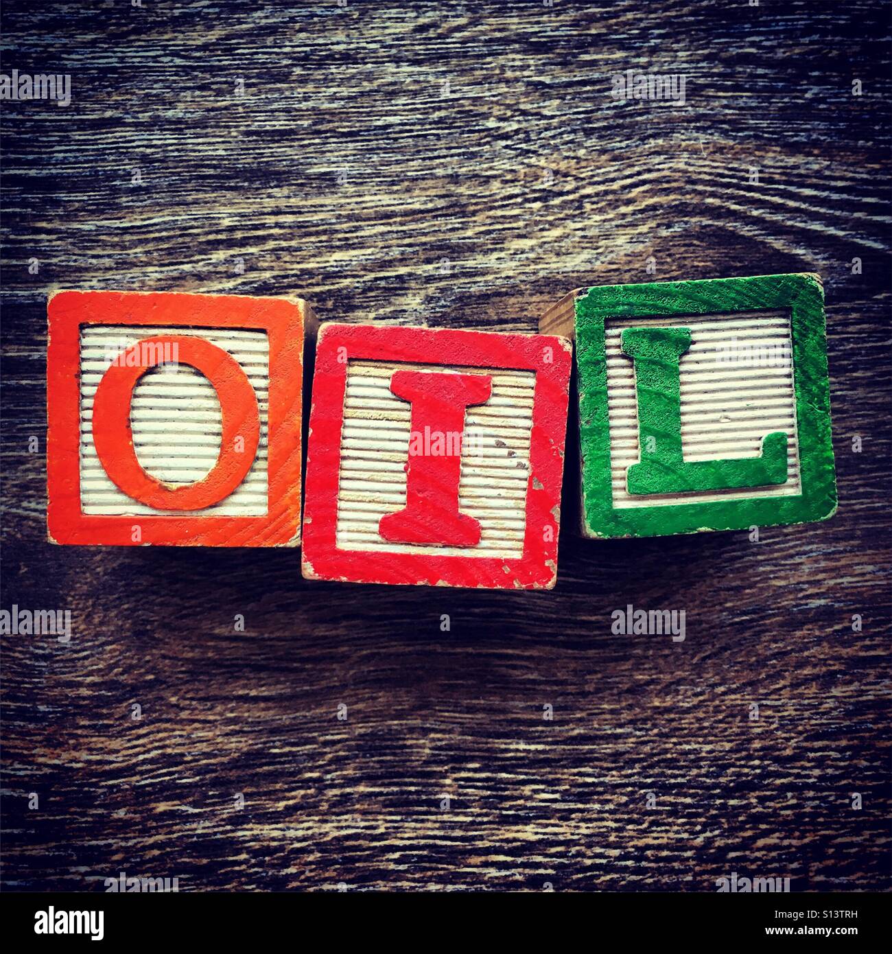 OIL word written with wood block letter toys - Smartphone Captured Stock Image
