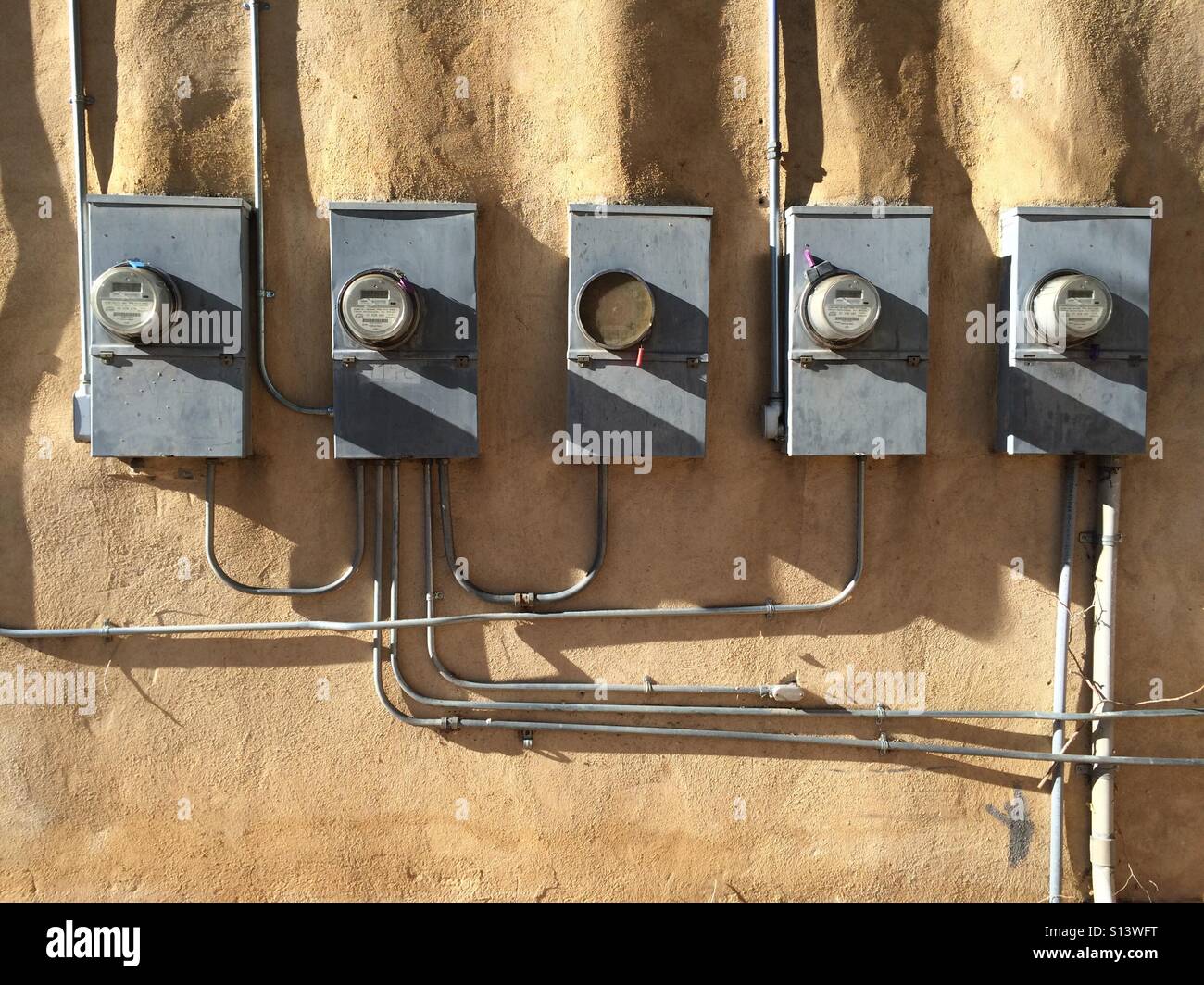 Electric meters on a wall. Stock Photo