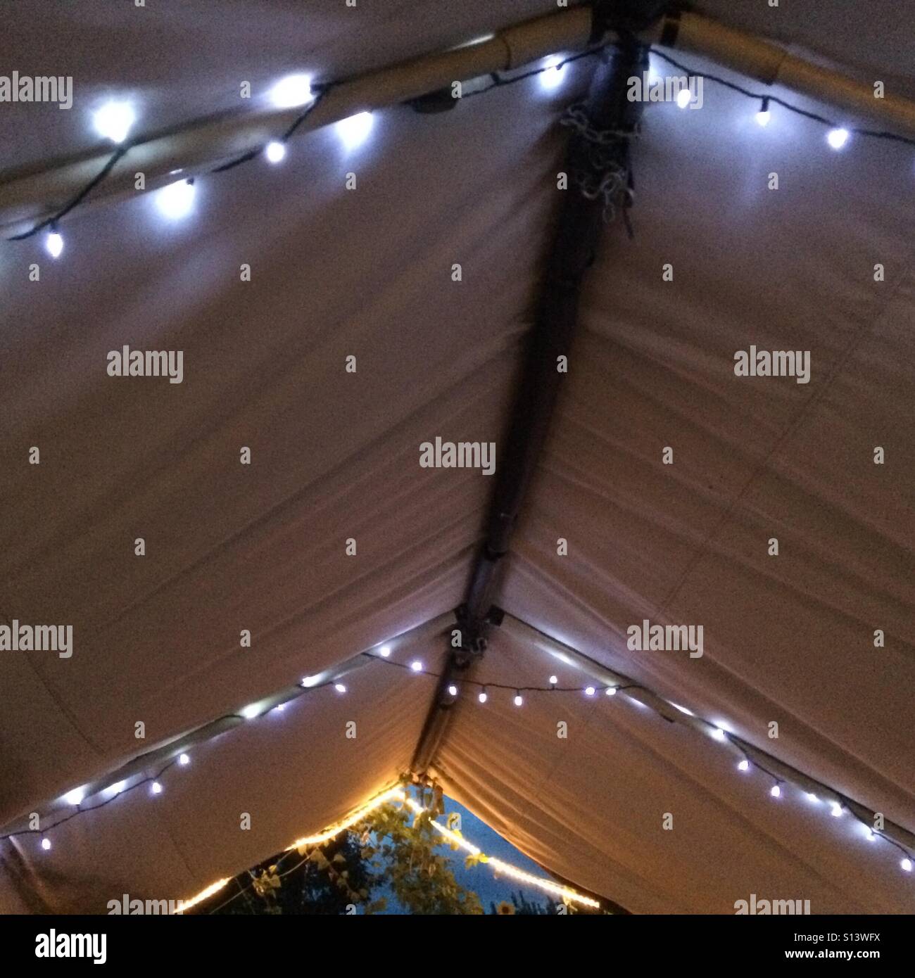 Decorative lights hang beneath a tent roof. Stock Photo